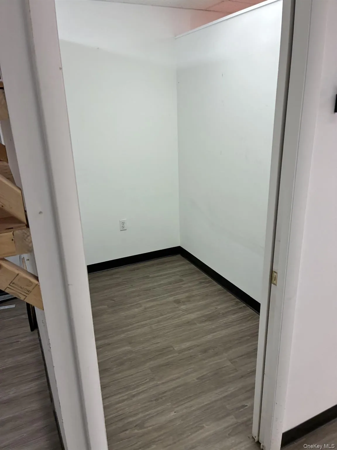 Empty room with dark wood finished floors and baseboards Empty room with dark wood finished floors and baseboards