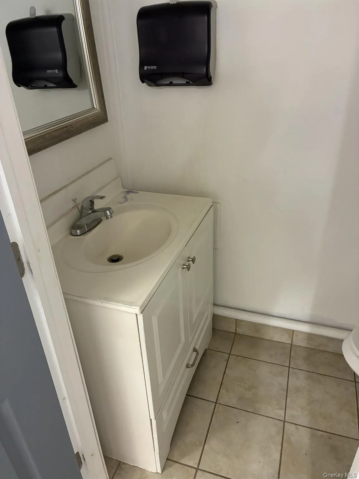 Bathroom with vanity and light tile patterned floors Bathroom with vanity and light tile patterned floors