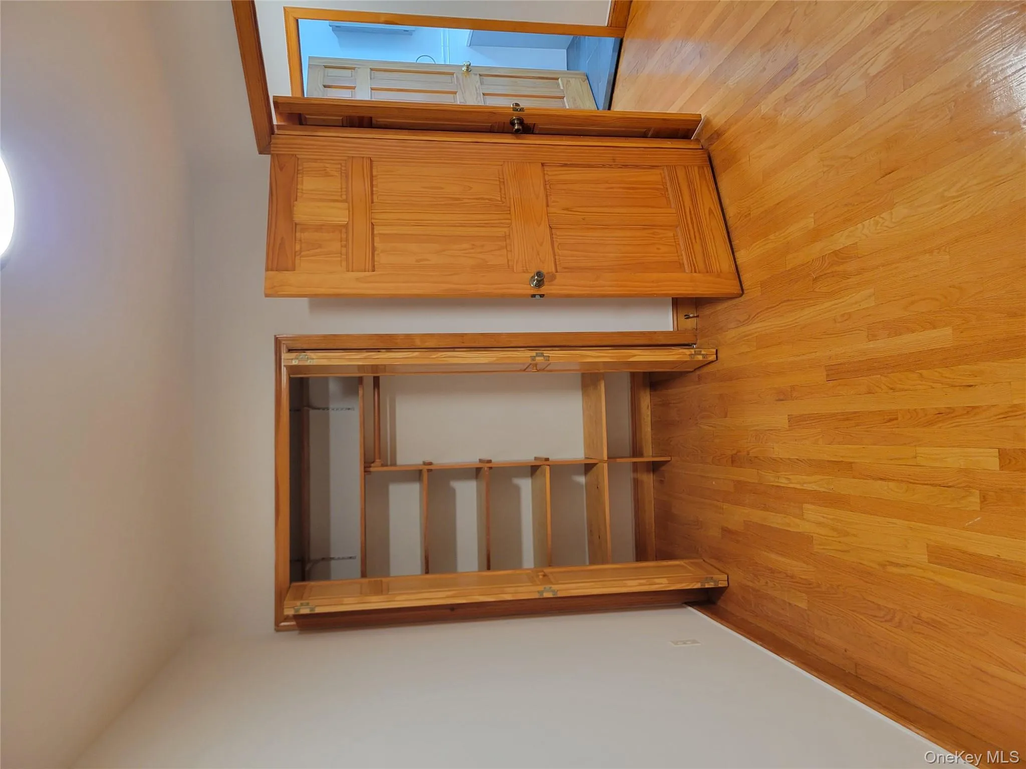 Unfurnished bedroom with a closet and light wood finished floors Unfurnished bedroom with a closet and light wood finished floors