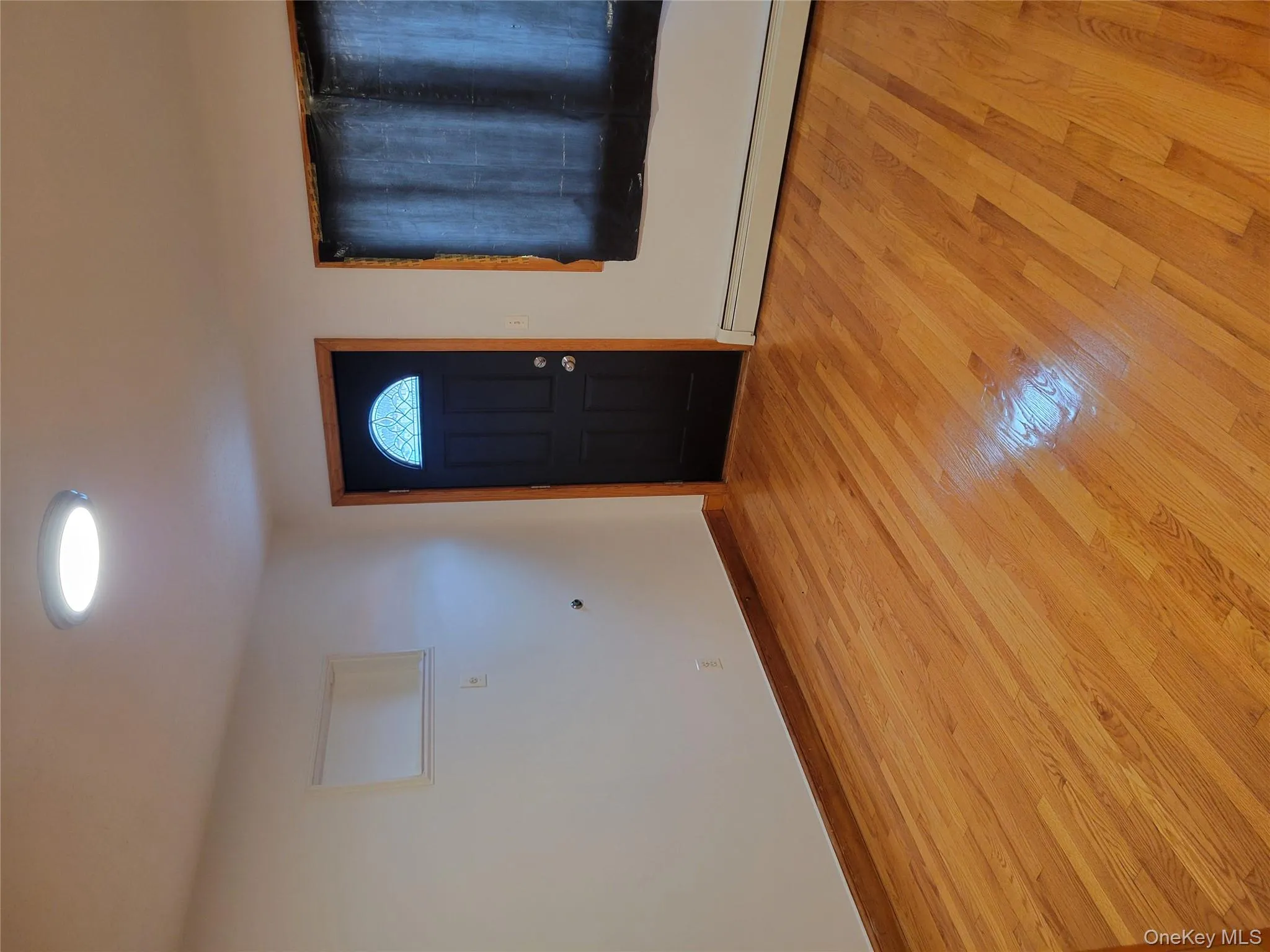 Entryway with a baseboard heating unit and light wood-style flooring Entryway with a baseboard heating unit and light wood-style flooring