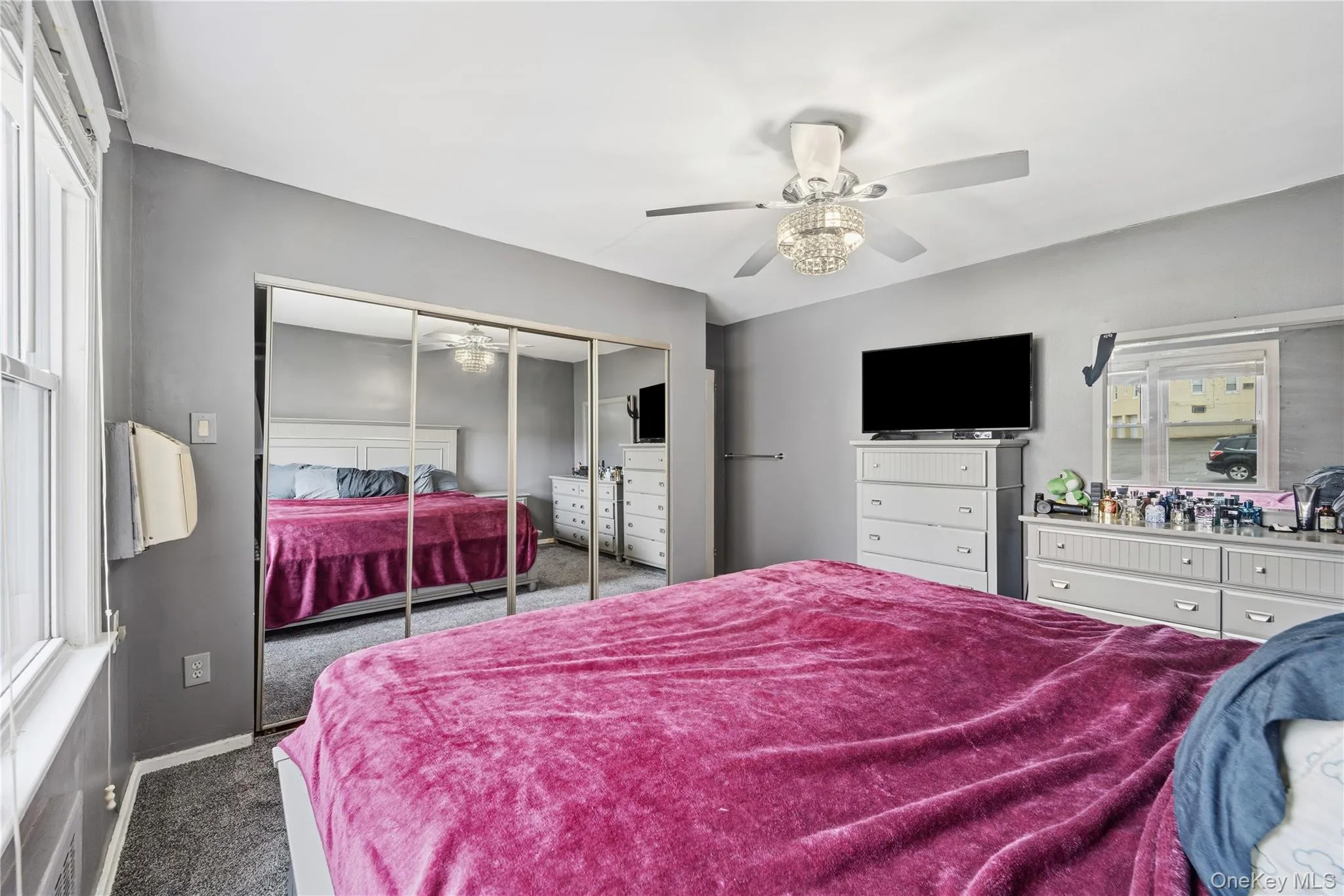 Bedroom featuring carpet flooring, a closet, and a ceiling fan Bedroom featuring carpet flooring, a closet, and a ceiling fan
