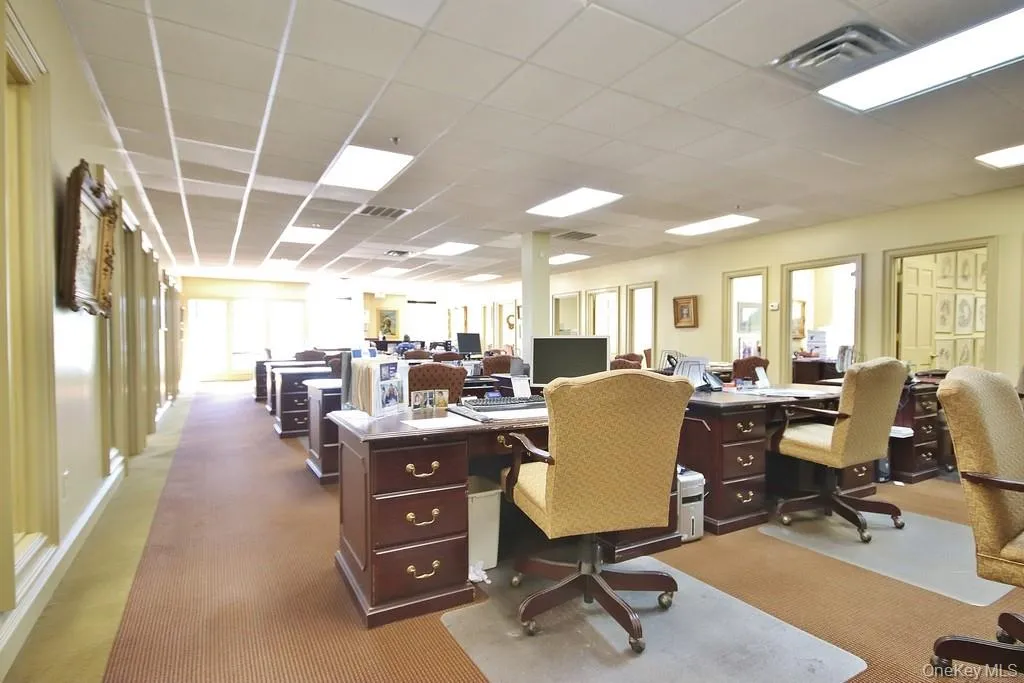 Home office with a paneled ceiling Home office with a paneled ceiling