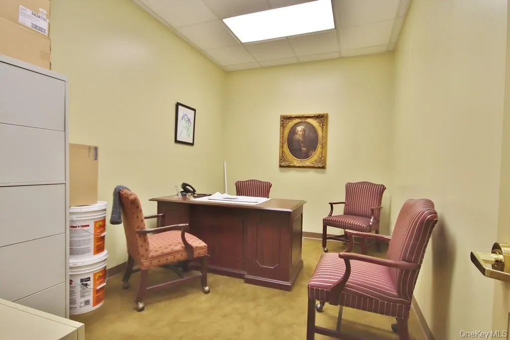 Office area featuring a drop ceiling Office area featuring a drop ceiling