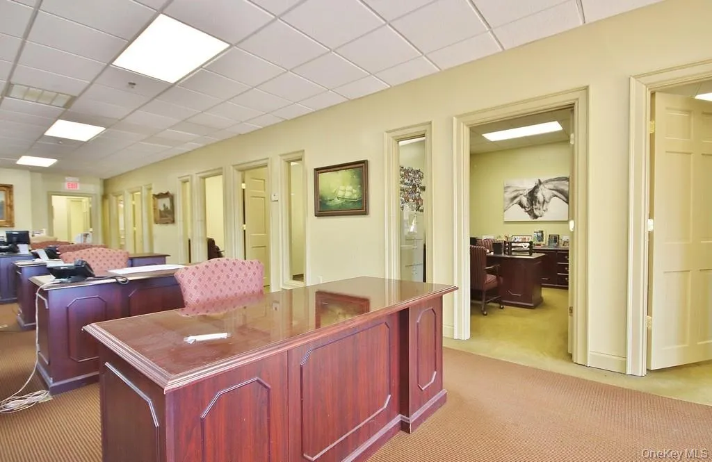 Home office with a paneled ceiling Home office with a paneled ceiling