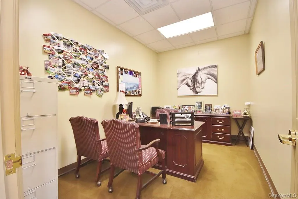 Office area featuring a drop ceiling Office area featuring a drop ceiling