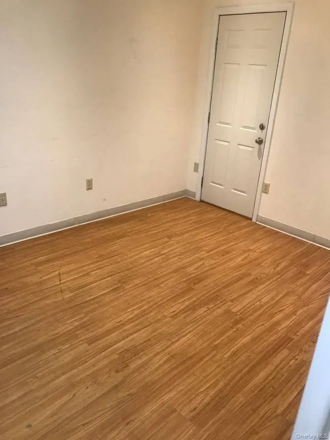 Spare room featuring light wood-style flooring and baseboards Spare room featuring light wood-style flooring and baseboards