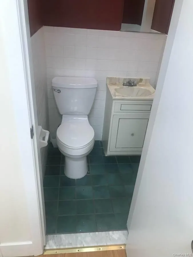 Bathroom with vanity and tile walls Bathroom with vanity and tile walls
