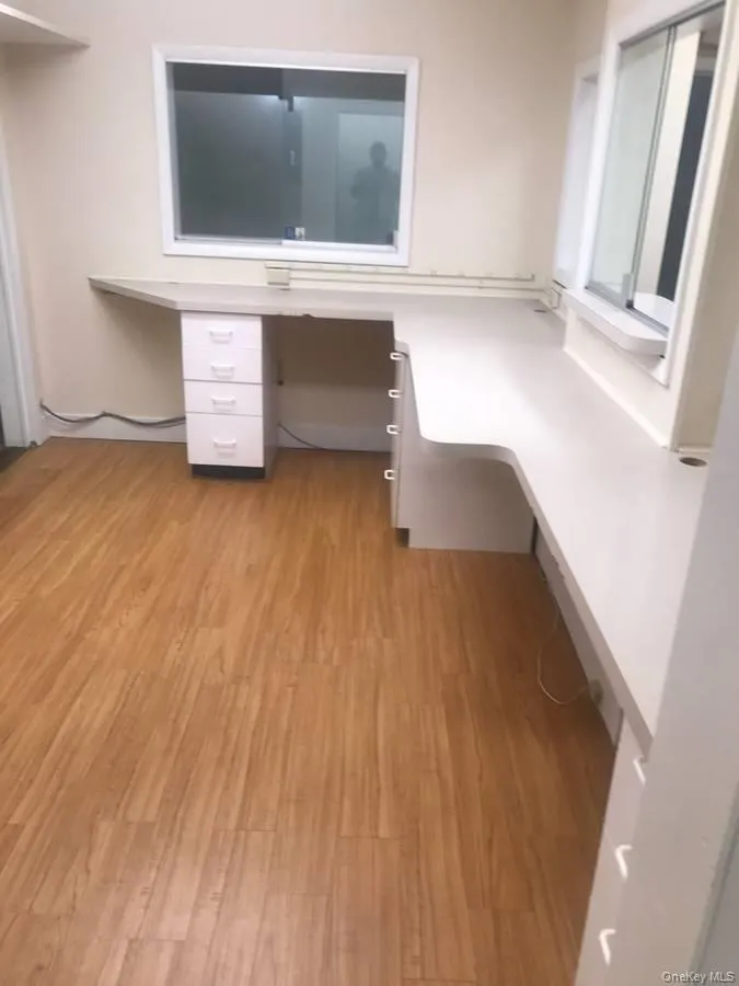 Unfurnished office with built in desk and light wood-type flooring Unfurnished office with built in desk and light wood-type flooring