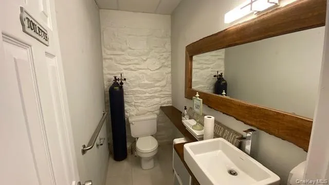 Bathroom featuring tile patterned flooring and vanity Bathroom featuring tile patterned flooring and vanity