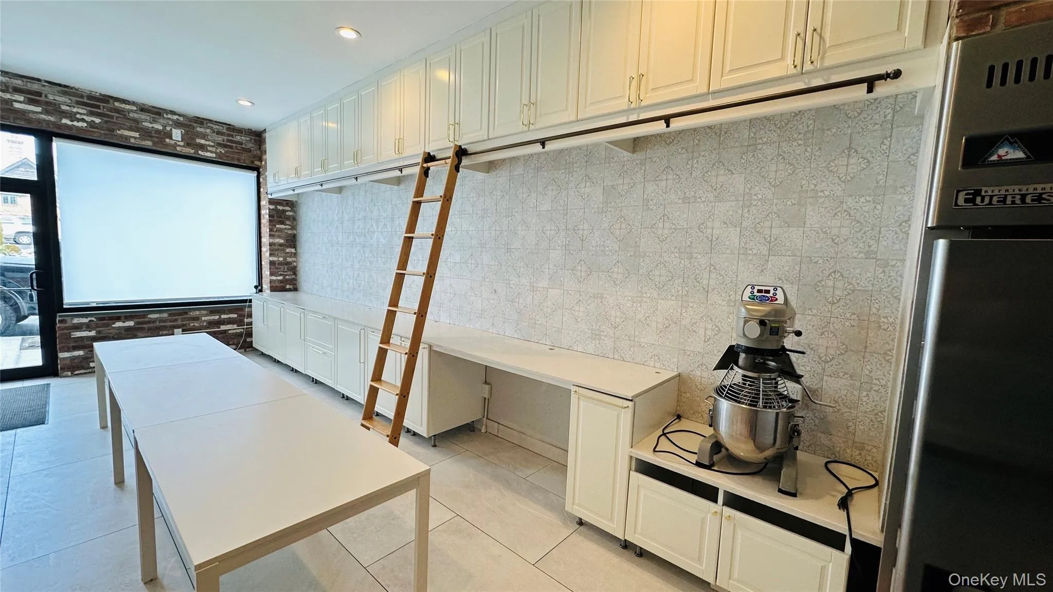 Expansive 24 foot continuous work-display counter with storage above. Expansive 24 foot continuous work-display counter with storage above.