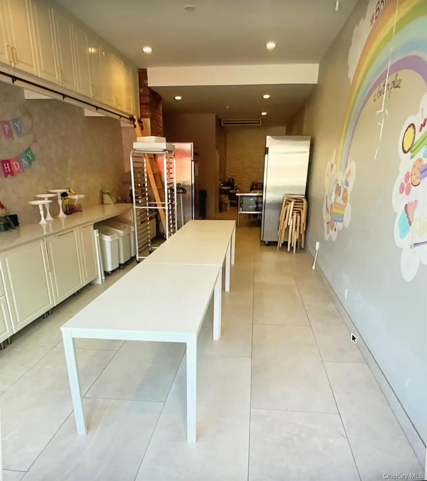 Kitchen with freestanding refrigerator, white cabinets, tasteful backsplash, recessed lighting, and light tile patterned flooring Kitchen with freestanding refrigerator, white cabinets, tasteful backsplash, recessed lighting, and light tile patterned flooring