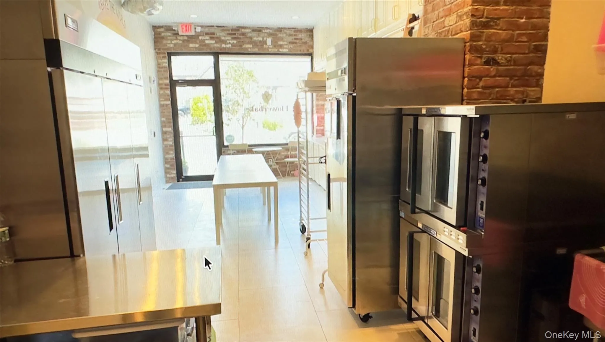 Kitchen with brick wall and stainless steel fridge Kitchen with brick wall and stainless steel fridge