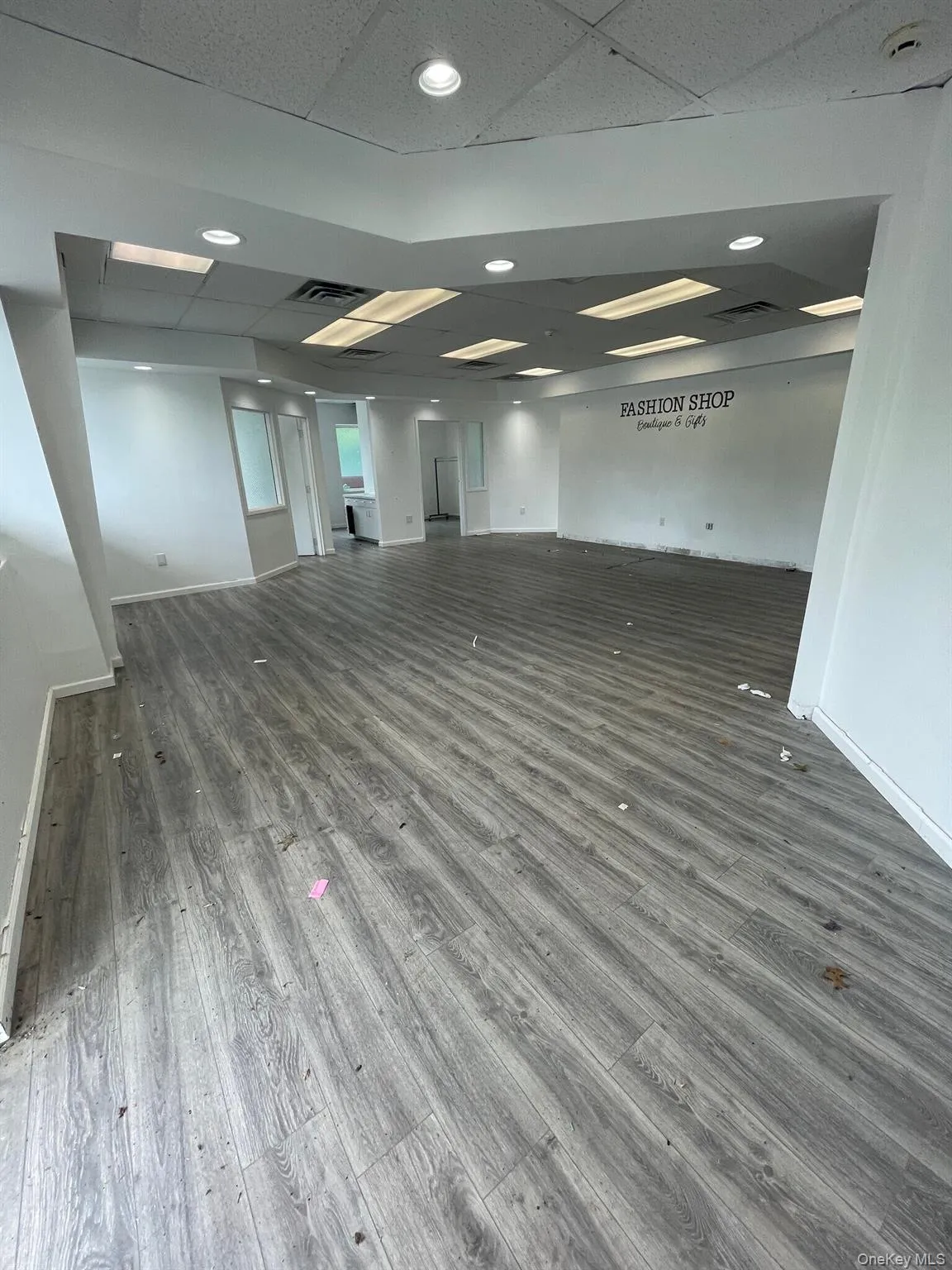 Spare room featuring a drop ceiling and wood finished floors Spare room featuring a drop ceiling and wood finished floors