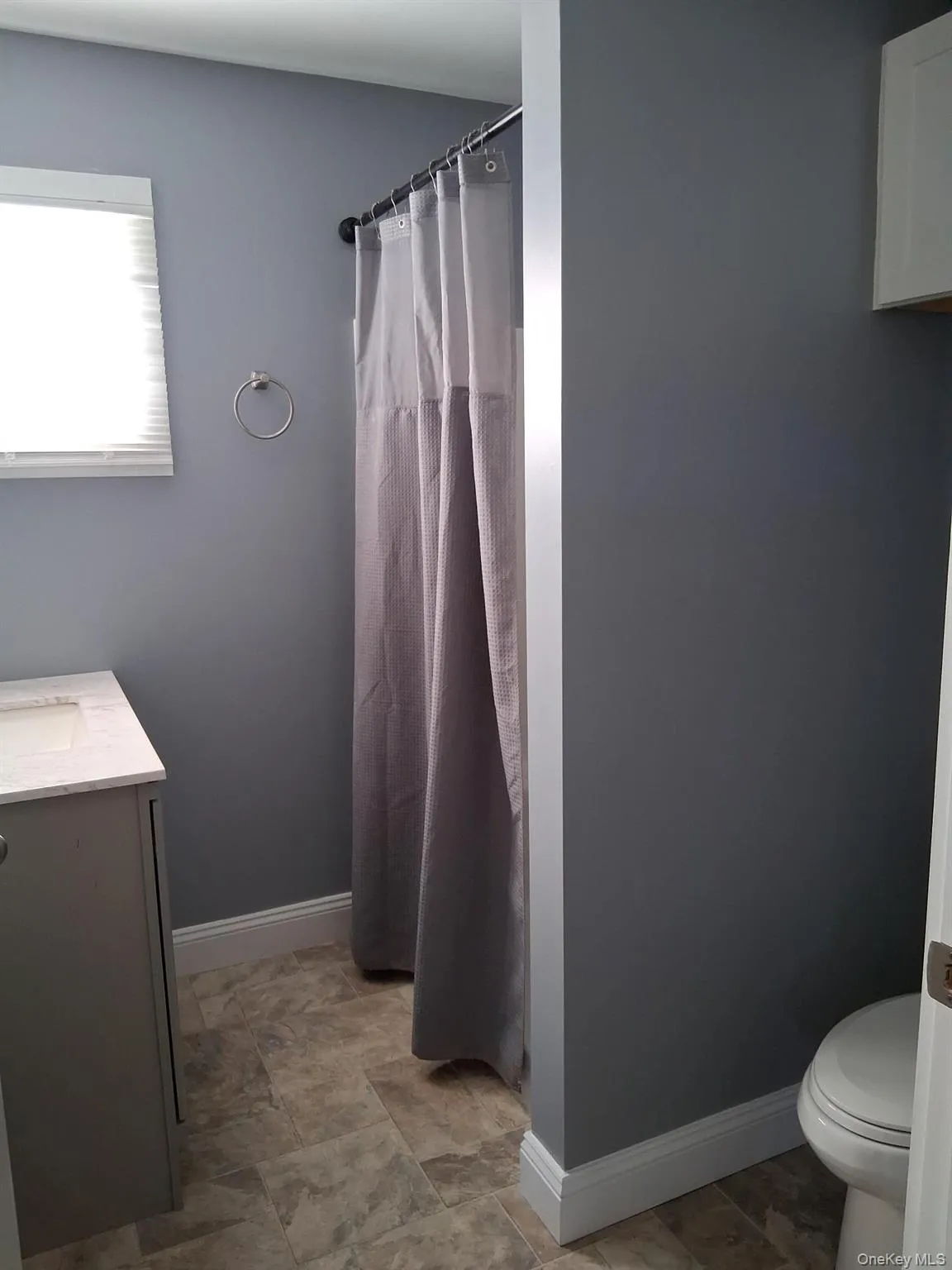 Bathroom with vanity and a shower with shower curtain Bathroom with vanity and a shower with shower curtain