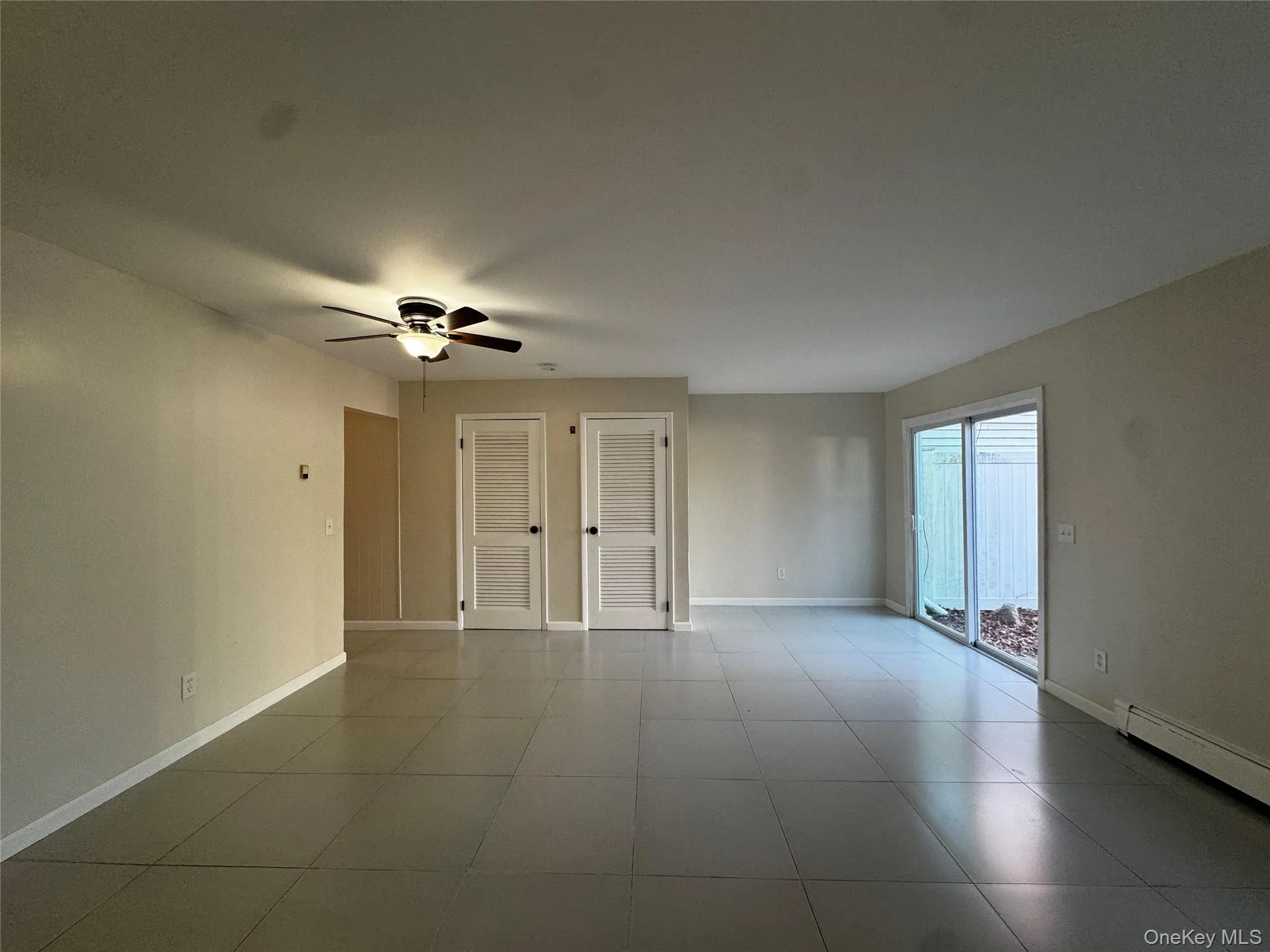 Living room with baseboards and ceiling fan Living room with baseboards and ceiling fan