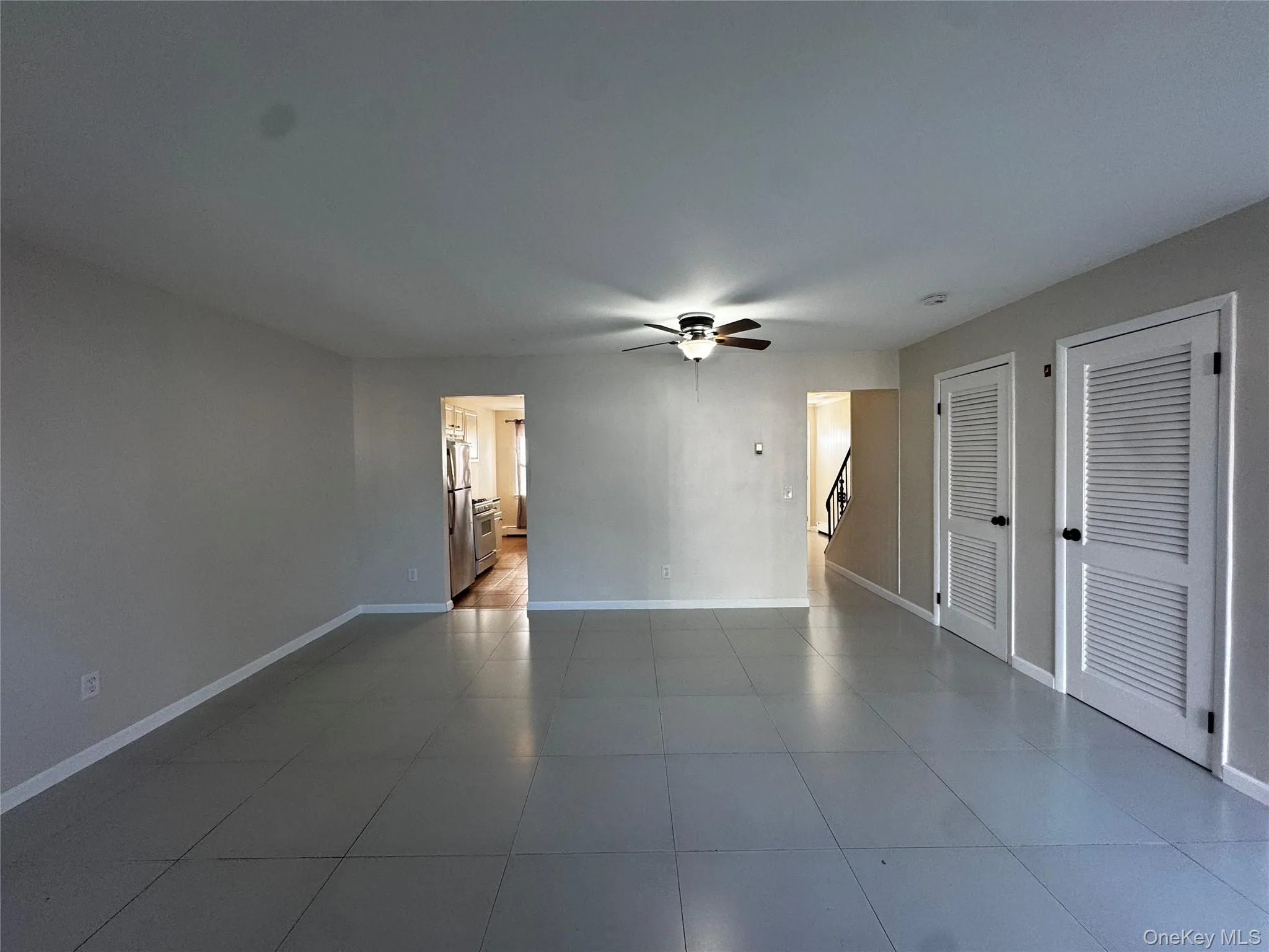Living/dining room combo featuring a ceiling fan and baseboards Living/dining room combo featuring a ceiling fan and baseboards