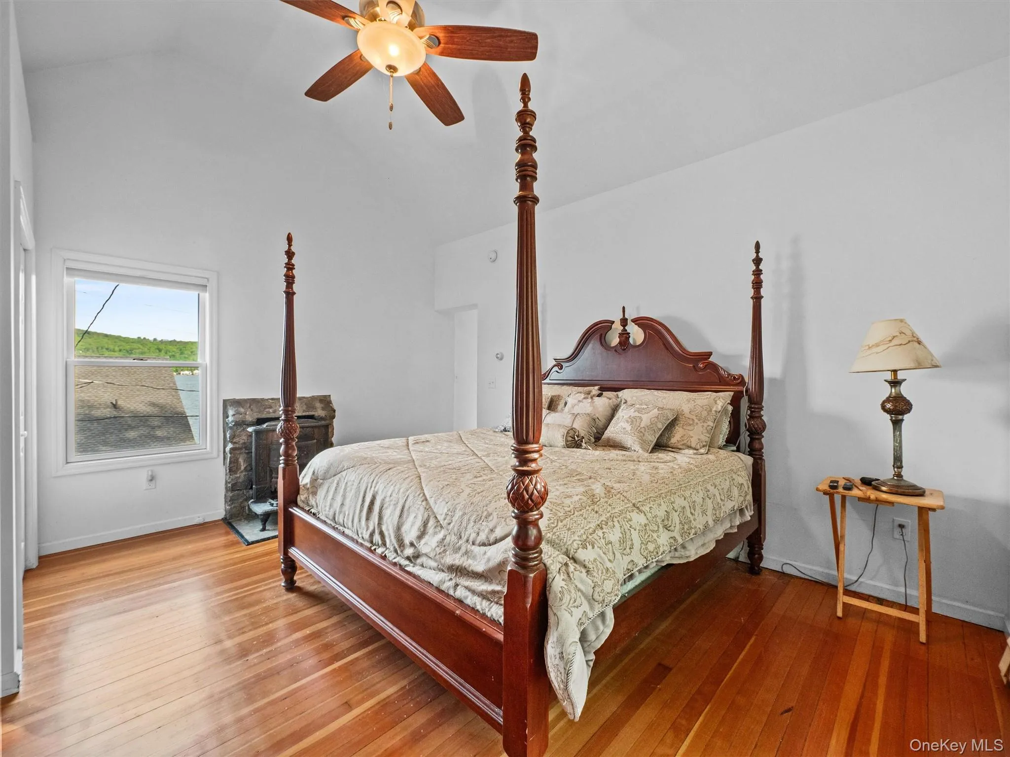 Bedroom featuring lofted ceiling, hardwood / wood-style floors, and ceiling fan Bedroom featuring lofted ceiling, hardwood / wood-style floors, and ceiling fan