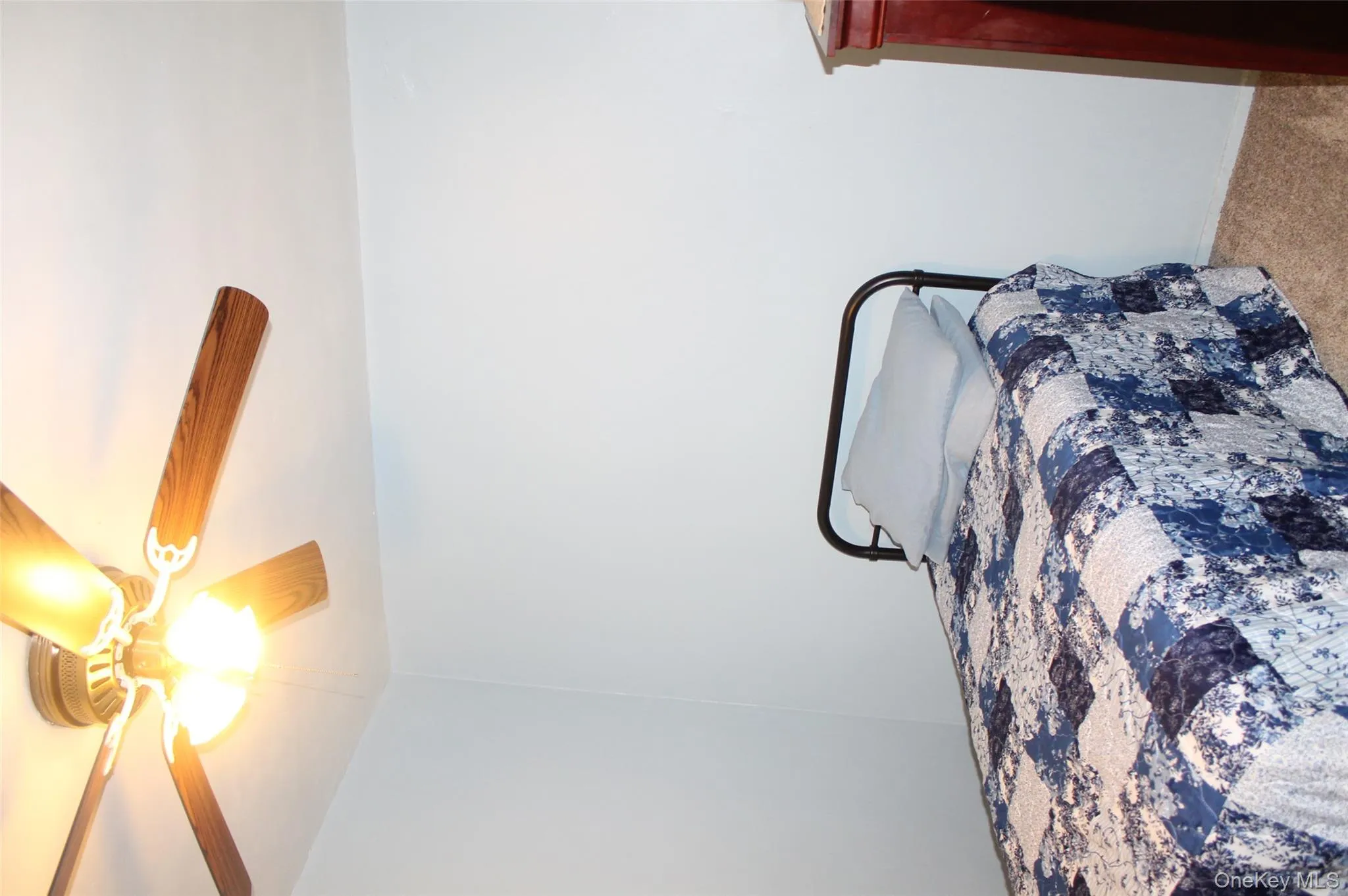 Carpeted bedroom featuring ceiling fan Carpeted bedroom featuring ceiling fan