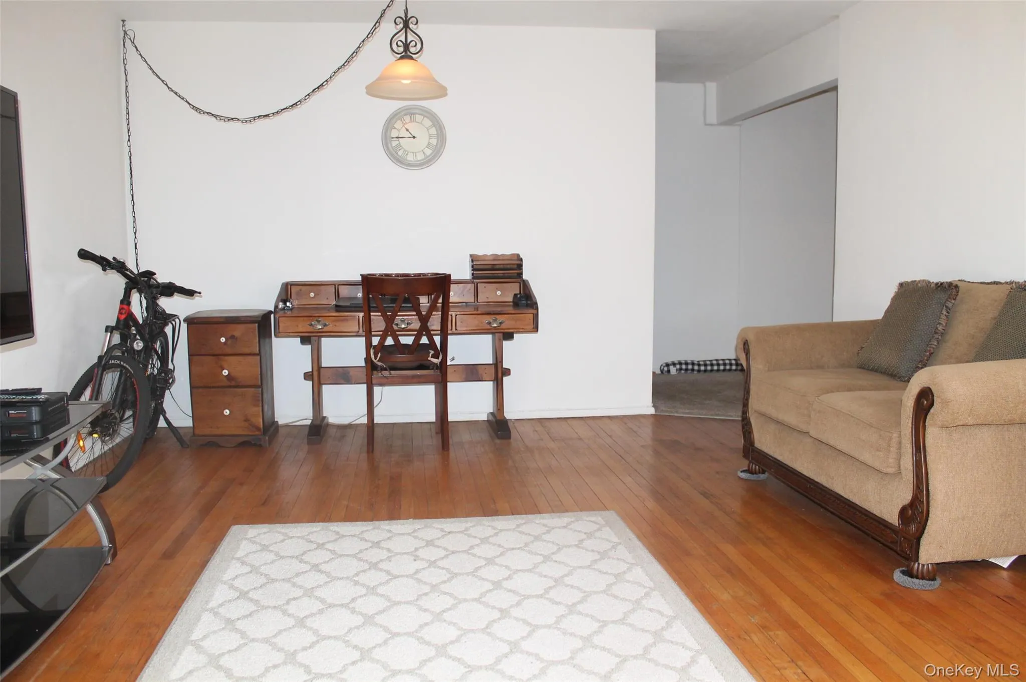 Living area with hardwood / wood-style flooring Living area with hardwood / wood-style flooring