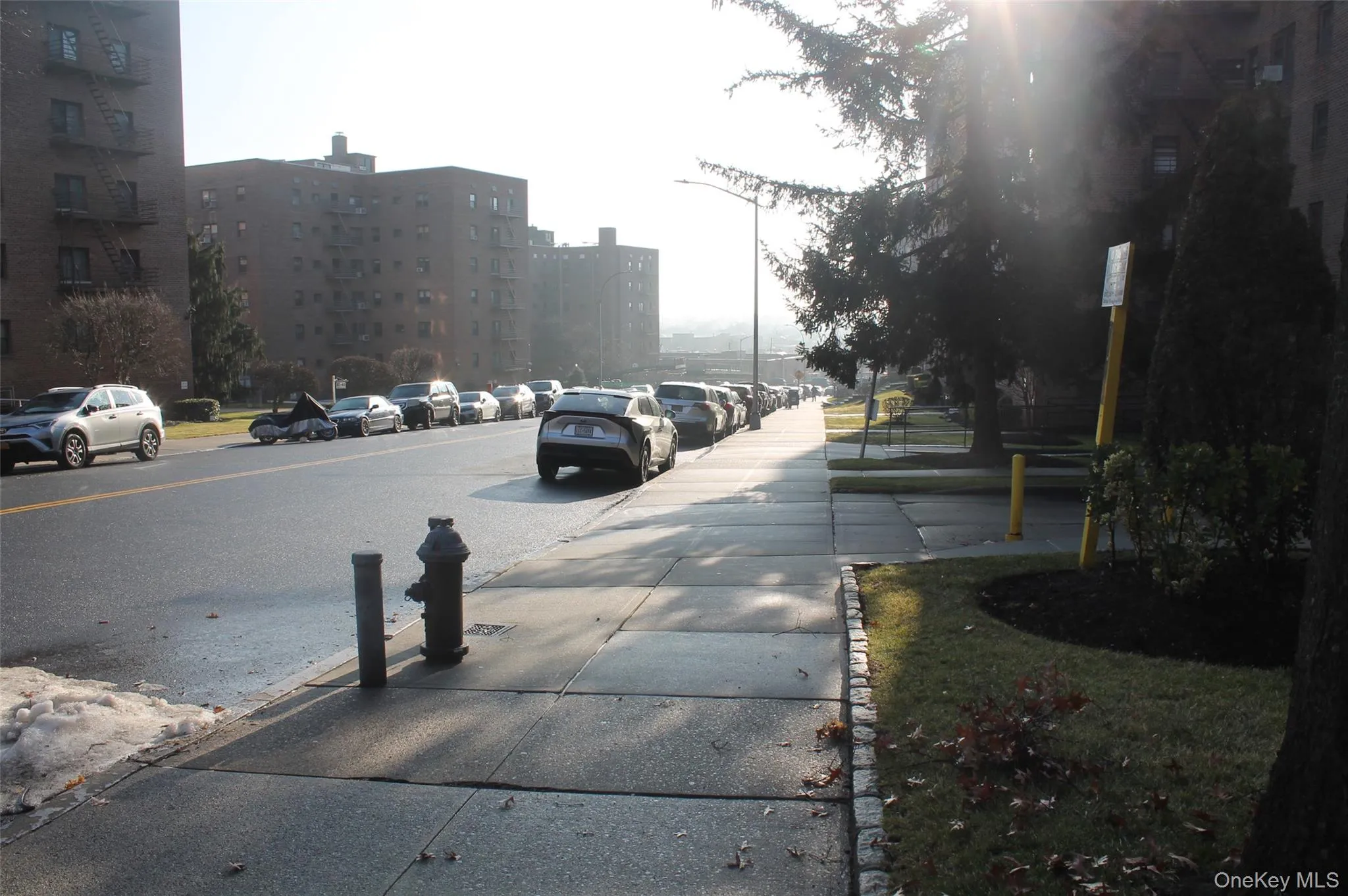 View of asphalt street with sidewalks View of asphalt street with sidewalks