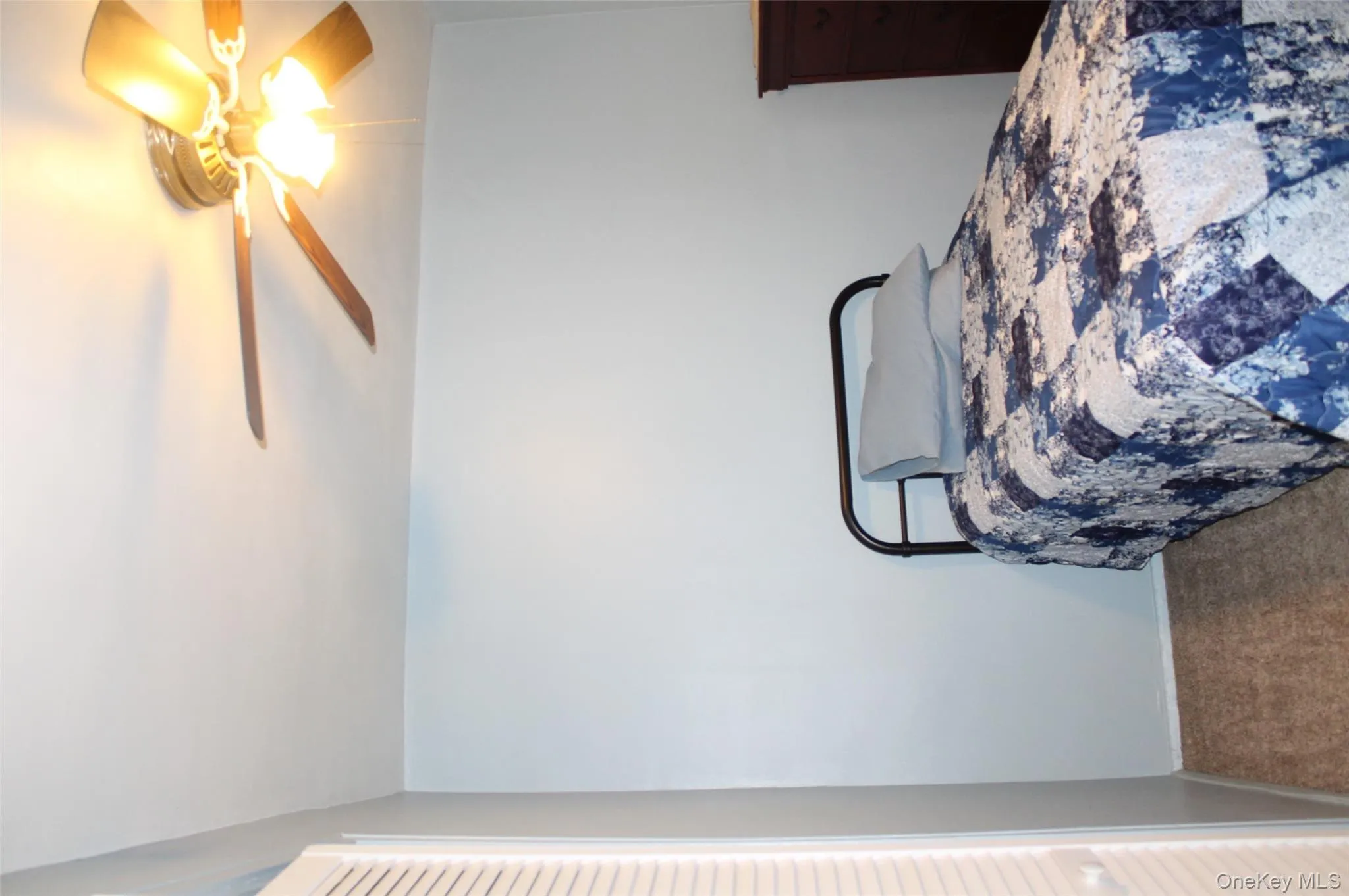 Carpeted bedroom featuring ceiling fan and baseboards Carpeted bedroom featuring ceiling fan and baseboards