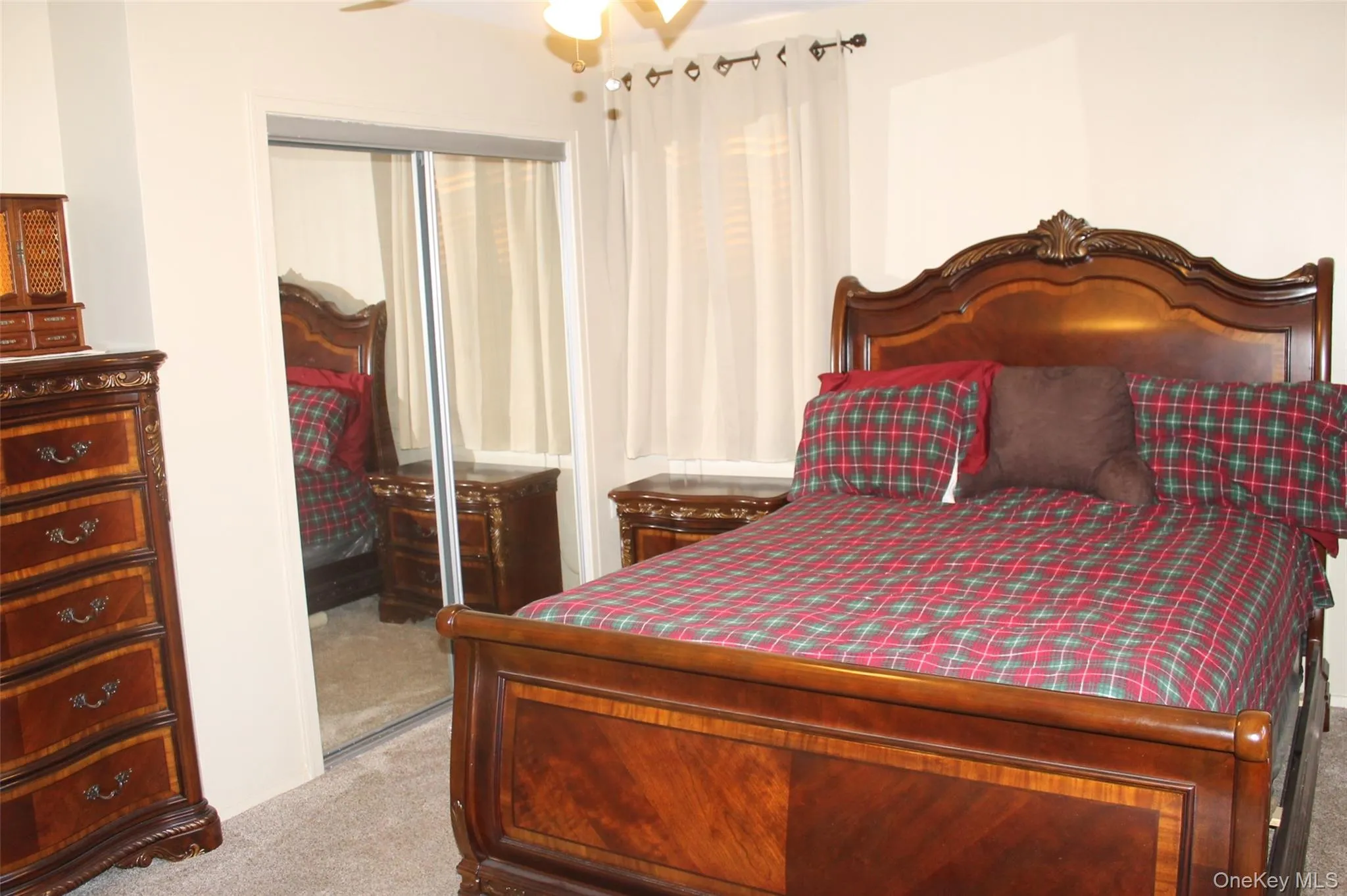 Bedroom featuring light colored carpet and a closet Bedroom featuring light colored carpet and a closet