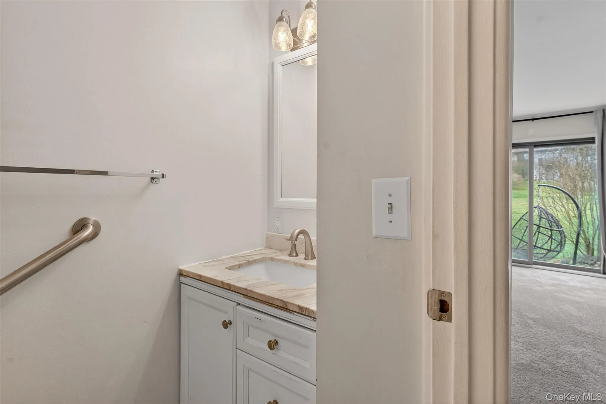 Bathroom featuring vanity and carpet Bathroom featuring vanity and carpet