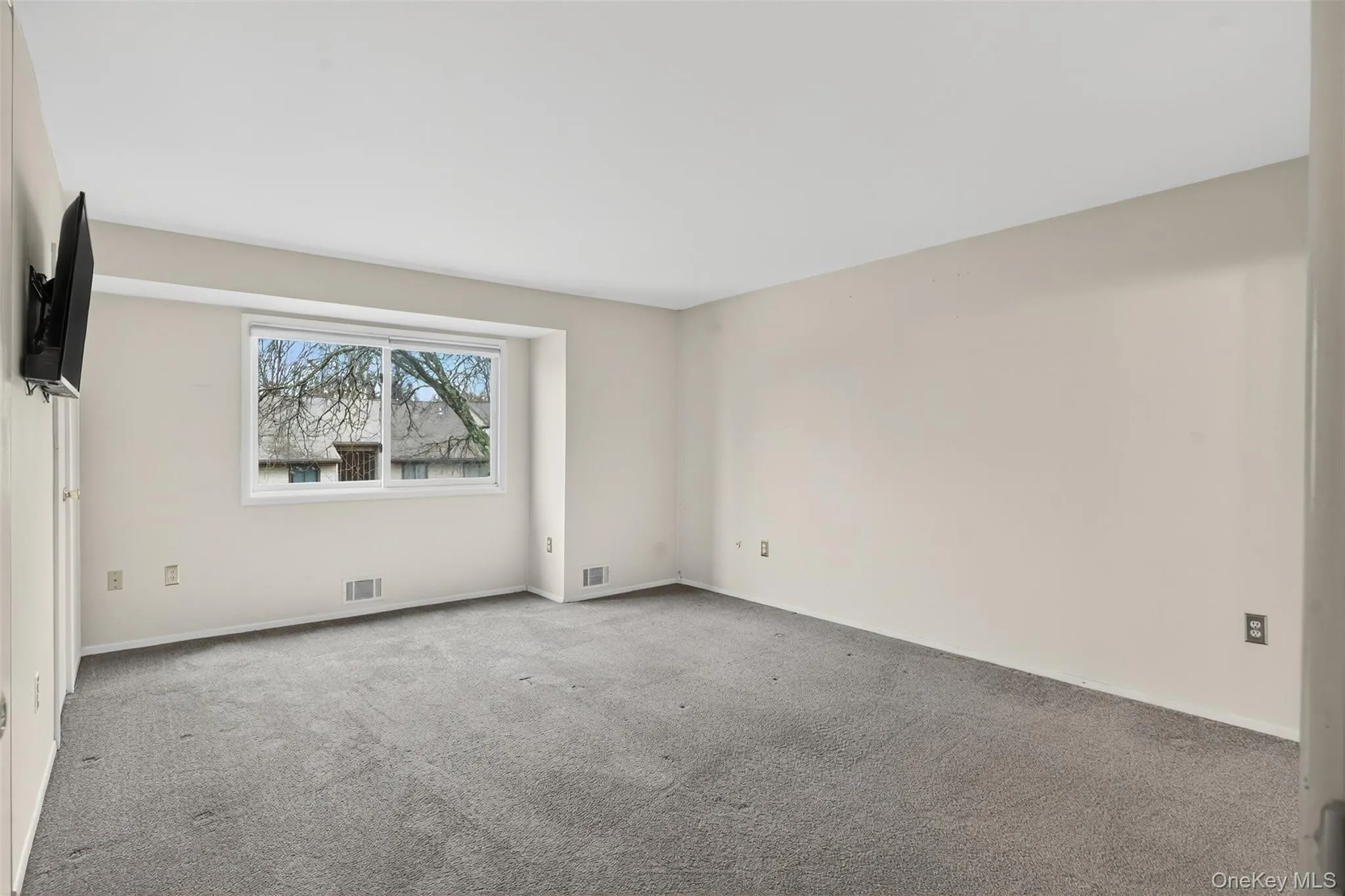 Empty room featuring carpet and baseboards Empty room featuring carpet and baseboards