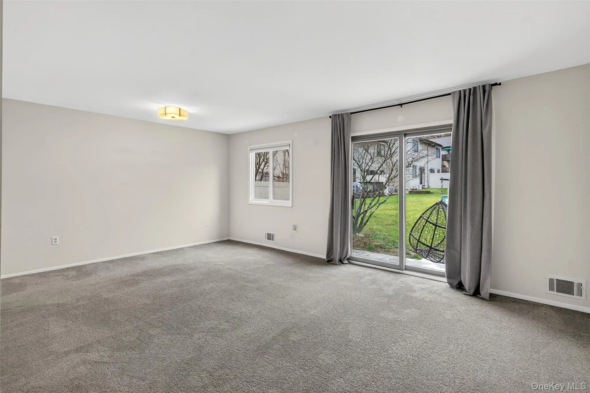 Empty room with carpet floors and baseboards Empty room with carpet floors and baseboards