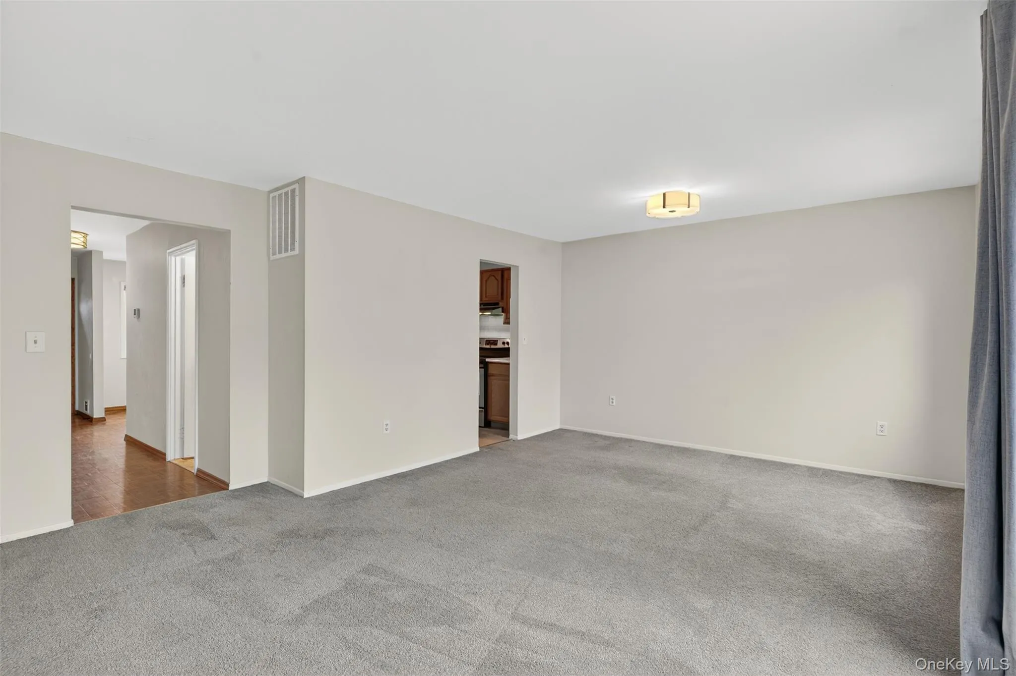 Unfurnished room with carpet floors and baseboards Unfurnished room with carpet floors and baseboards