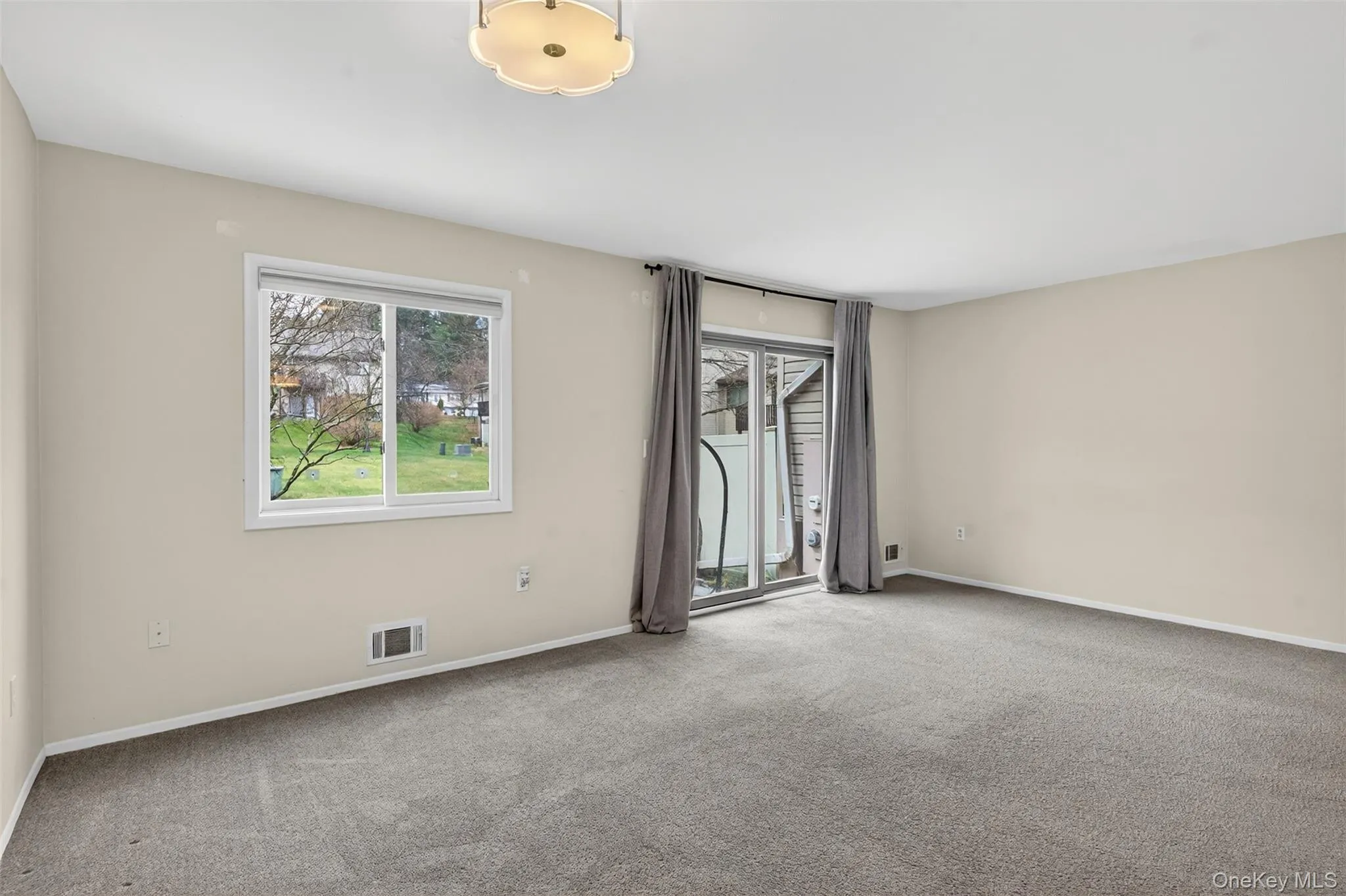 Carpeted empty room featuring baseboards Carpeted empty room featuring baseboards