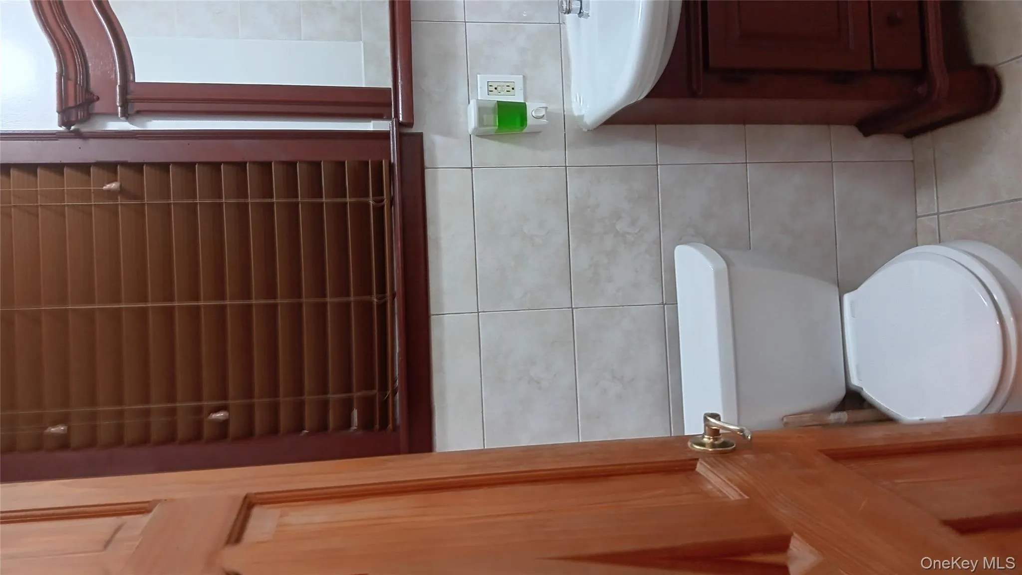 Half bath with light tile patterned floors, vanity, and tile walls Half bath with light tile patterned floors, vanity, and tile walls