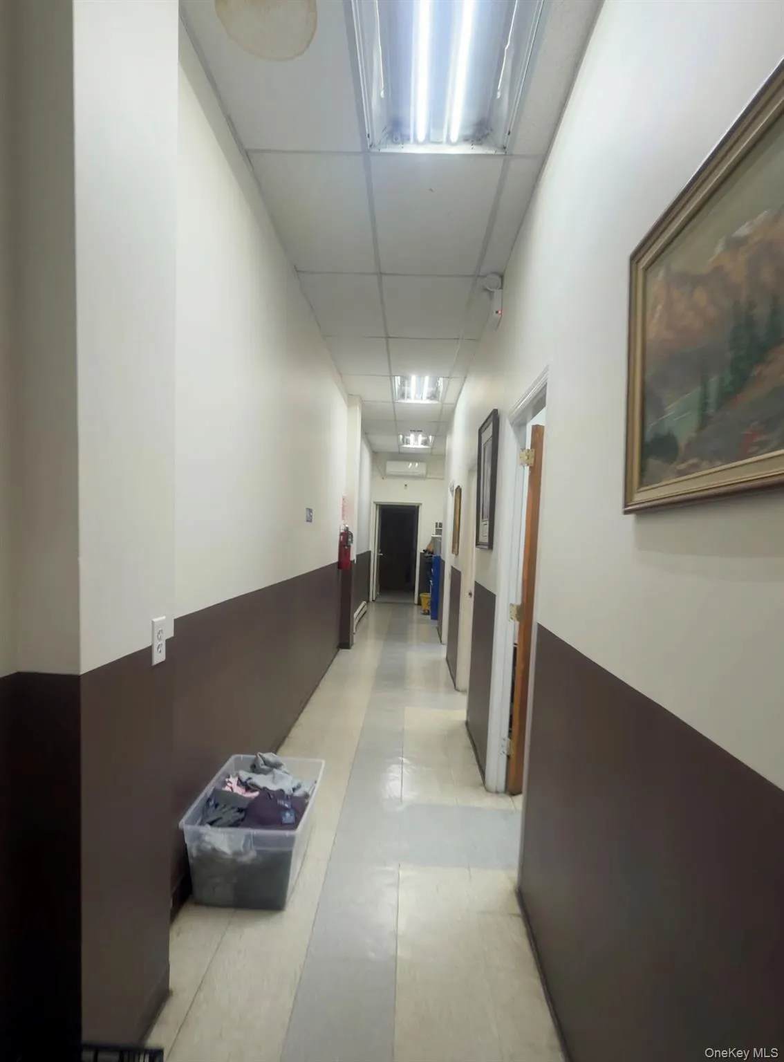 Hallway with a paneled ceiling Hallway with a paneled ceiling