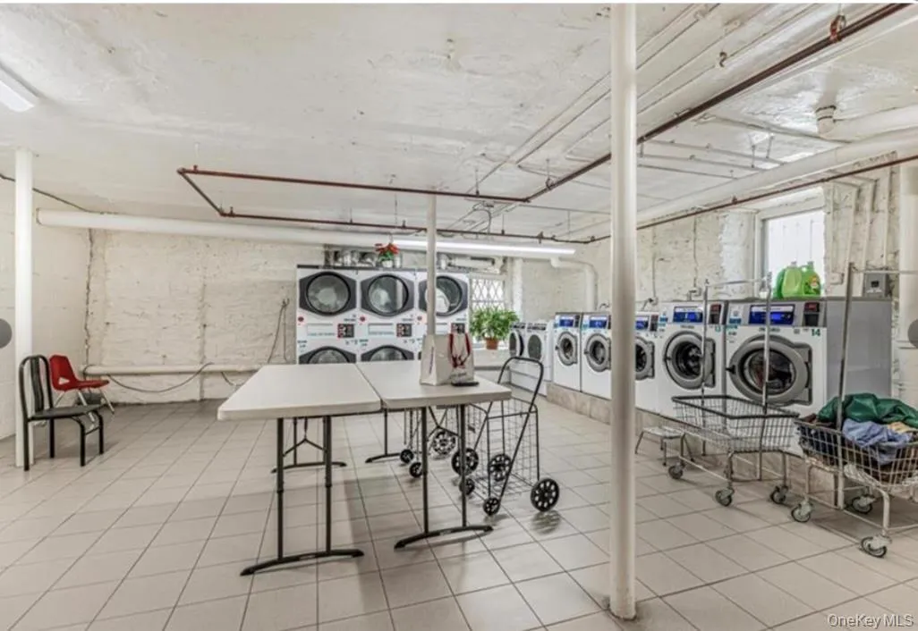 Washroom featuring stacked washer and clothes dryer and independent washer and dryer Washroom featuring stacked washer and clothes dryer and independent washer and dryer