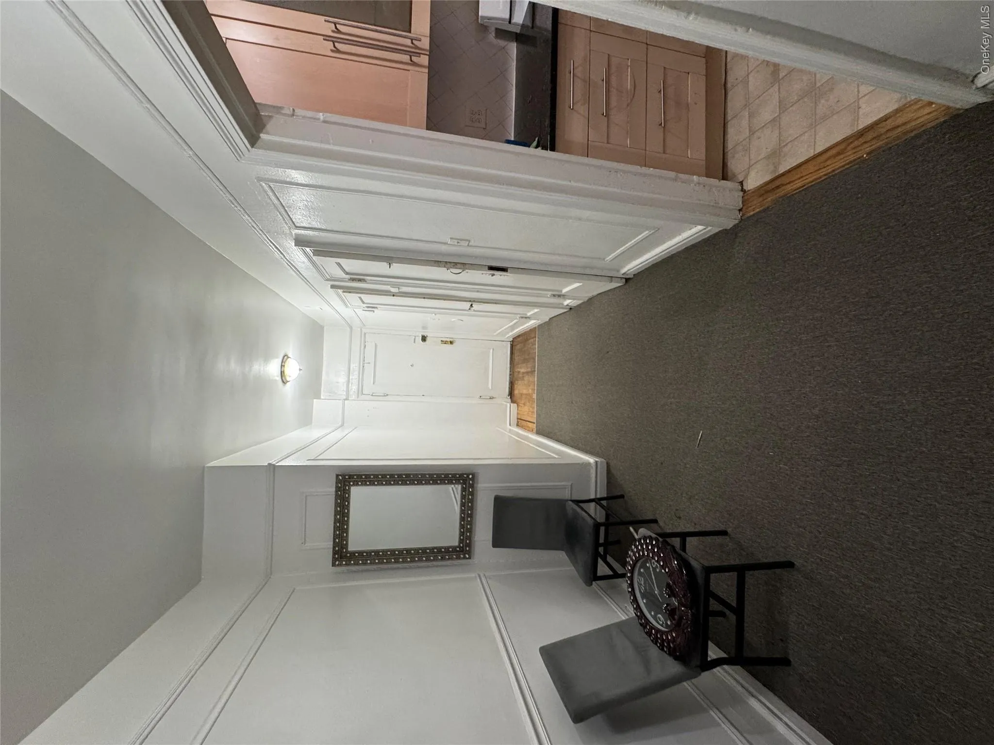 Hall with dark carpet and a decorative wall Hall with dark carpet and a decorative wall