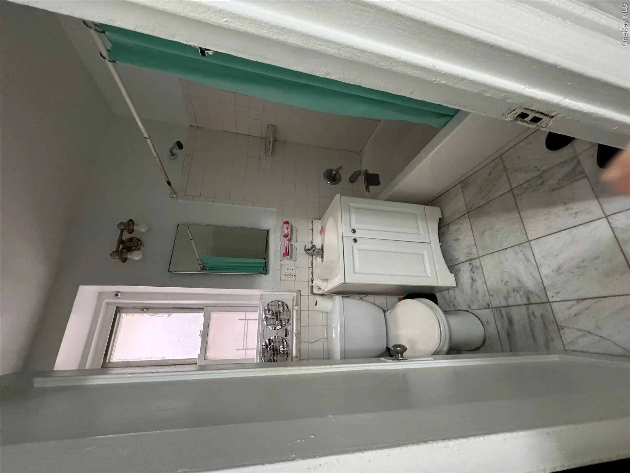 Bathroom with vanity, shower / tub combo with curtain, and tile walls Bathroom with vanity, shower / tub combo with curtain, and tile walls