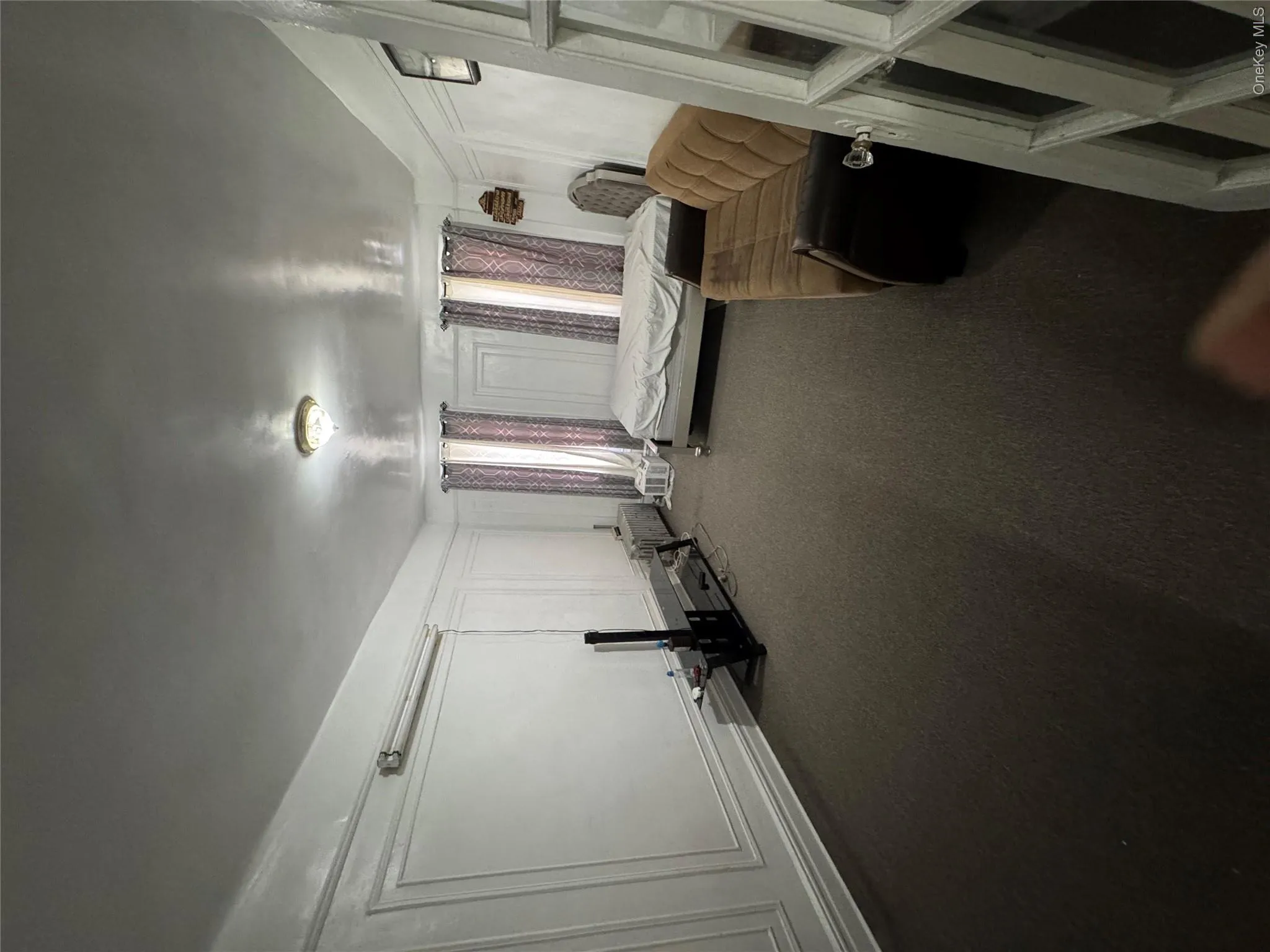 Carpeted bedroom featuring a decorative wall Carpeted bedroom featuring a decorative wall