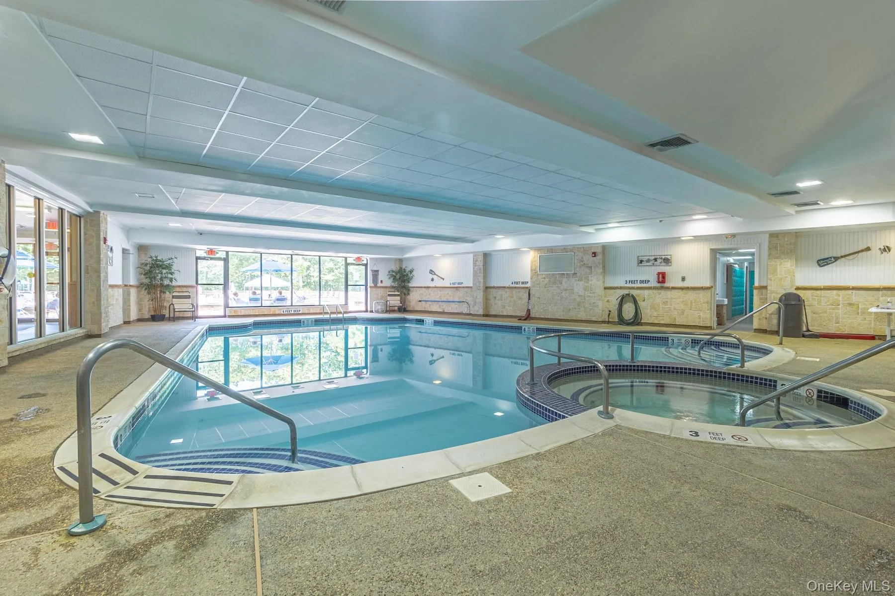 View of swimming pool featuring a pool with connected hot tub View of swimming pool featuring a pool with connected hot tub
