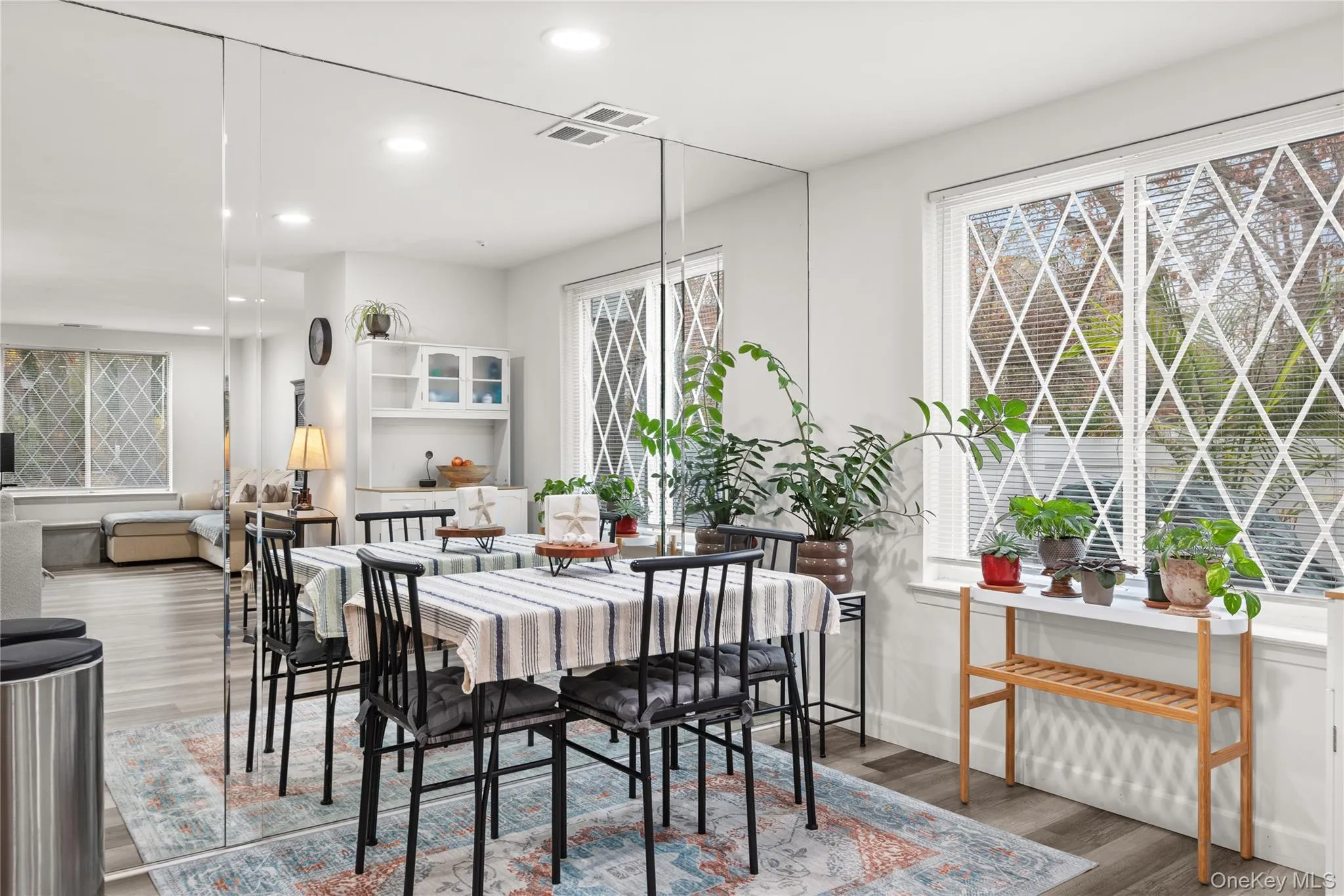 Dining room featuring light wood-style flooring and recessed lighting Dining room featuring light wood-style flooring and recessed lighting