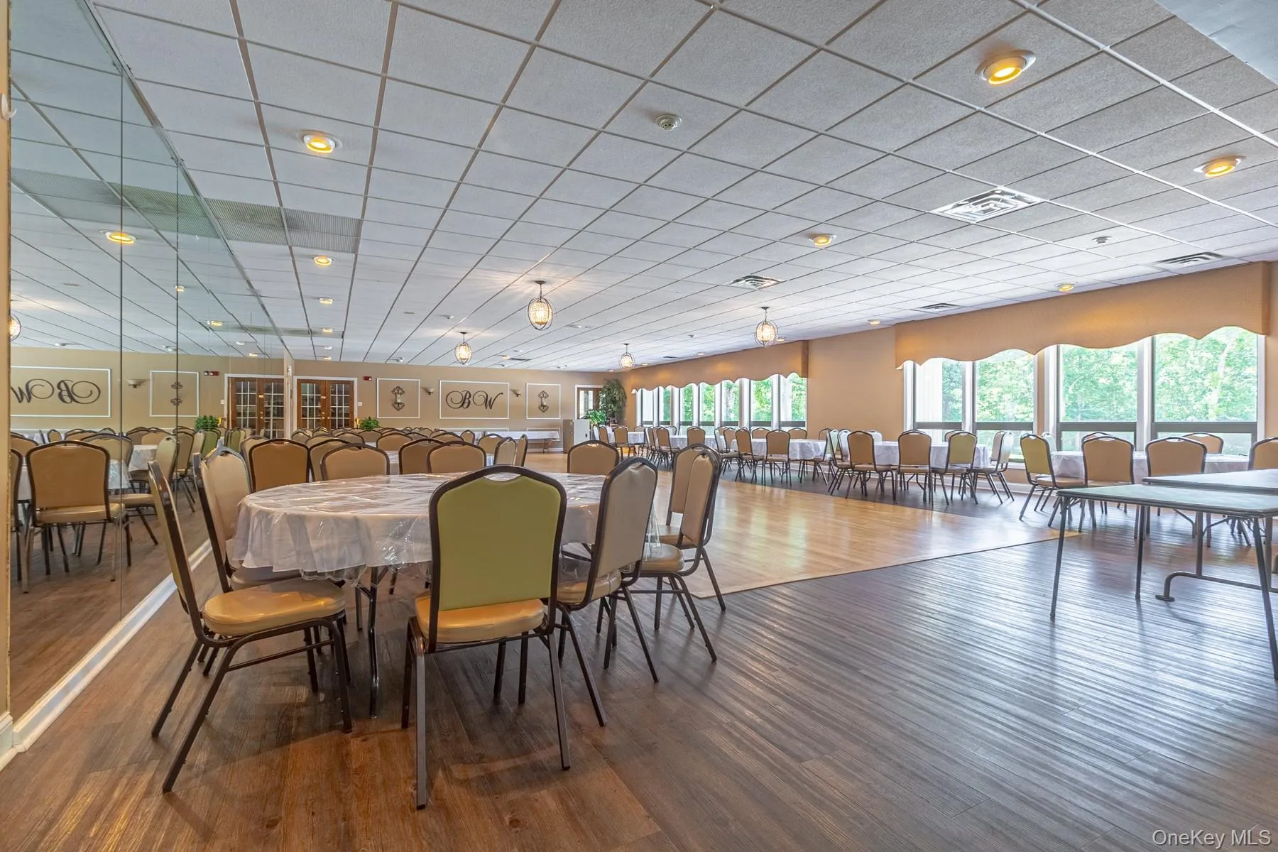 Dining room featuring wood finished floors and a paneled ceiling Dining room featuring wood finished floors and a paneled ceiling