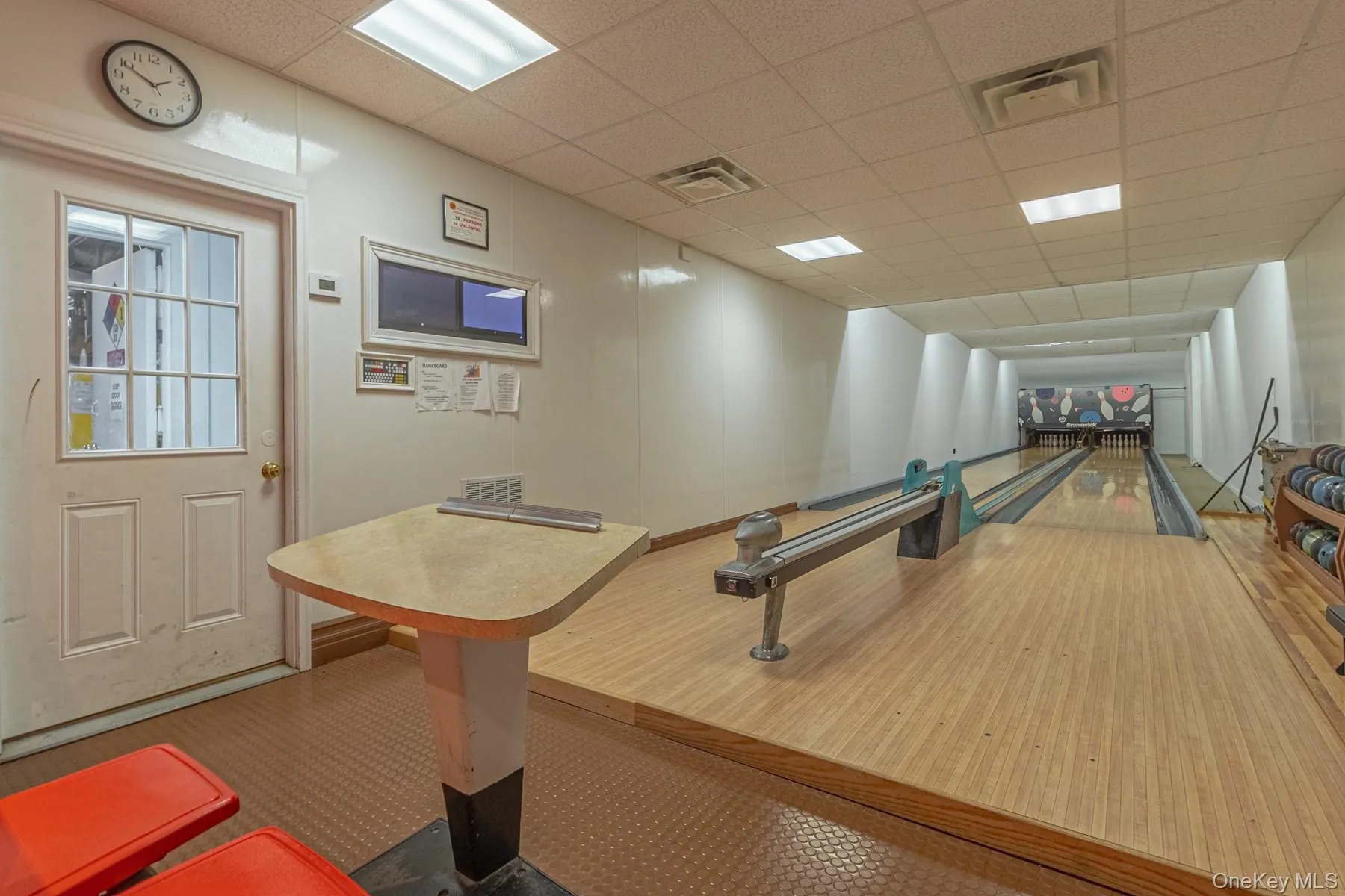 Rec room featuring a paneled ceiling and a bowling alley Rec room featuring a paneled ceiling and a bowling alley