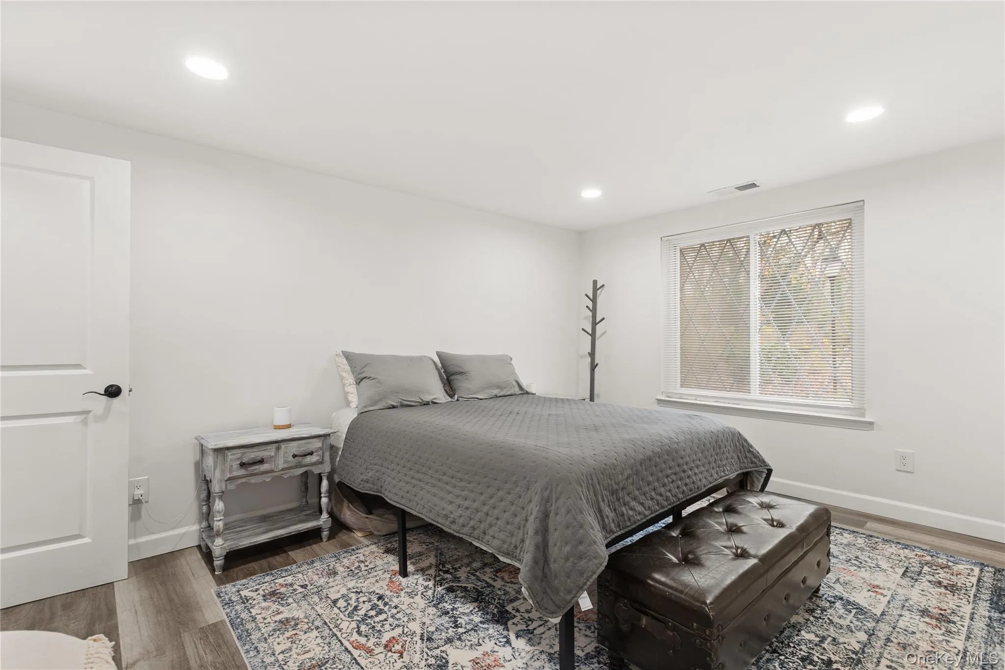 Bedroom with wood finished floors and recessed lighting Bedroom with wood finished floors and recessed lighting