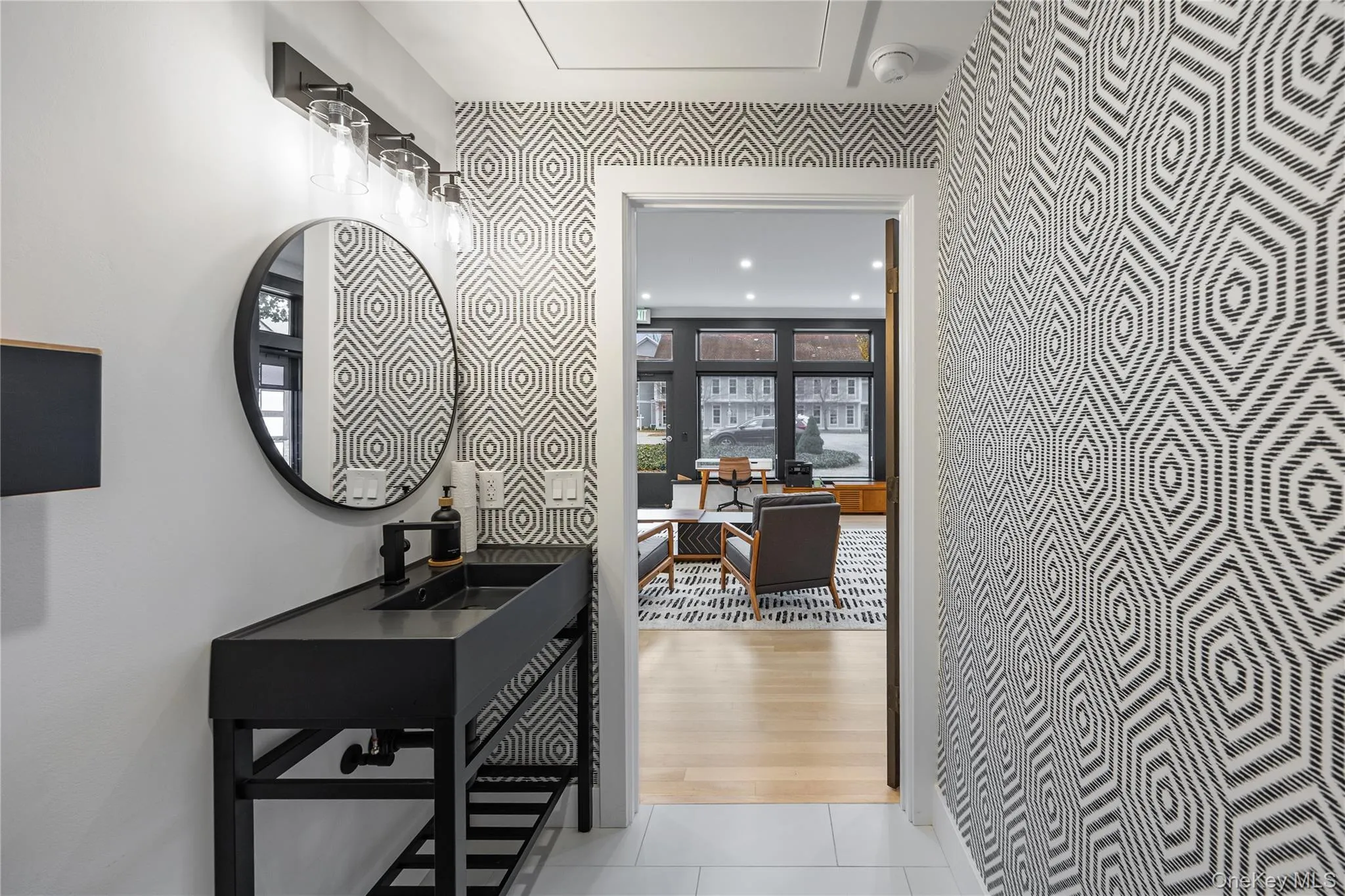 Corridor featuring a desk and light tile patterned floors Corridor featuring a desk and light tile patterned floors
