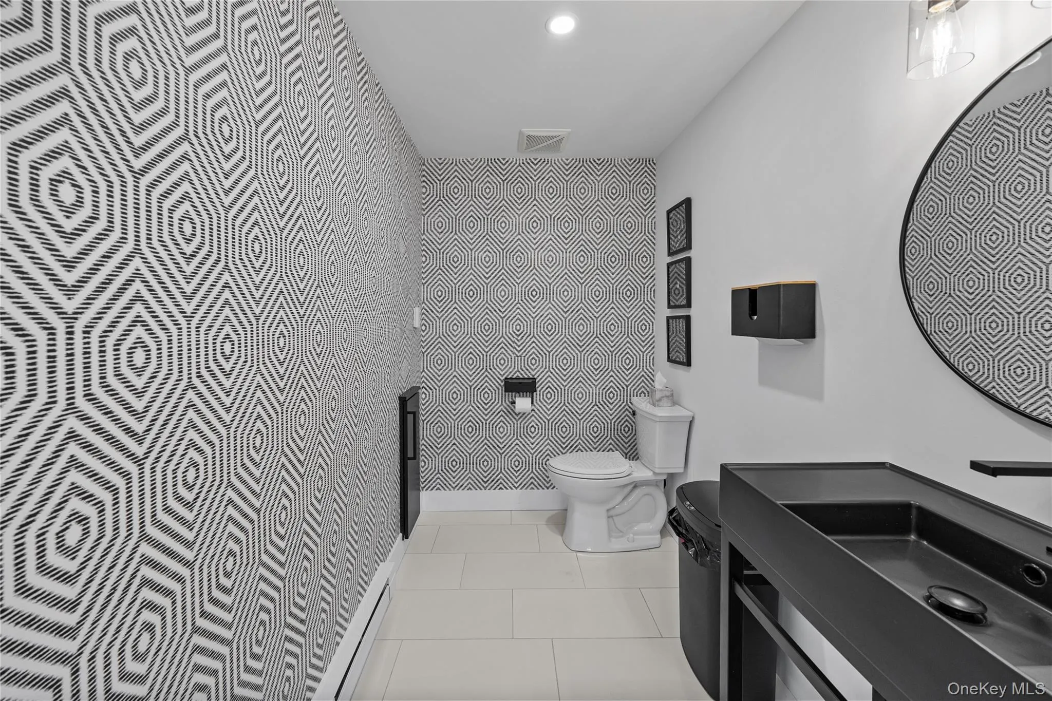 Half bath with tile patterned flooring and vanity Half bath with tile patterned flooring and vanity