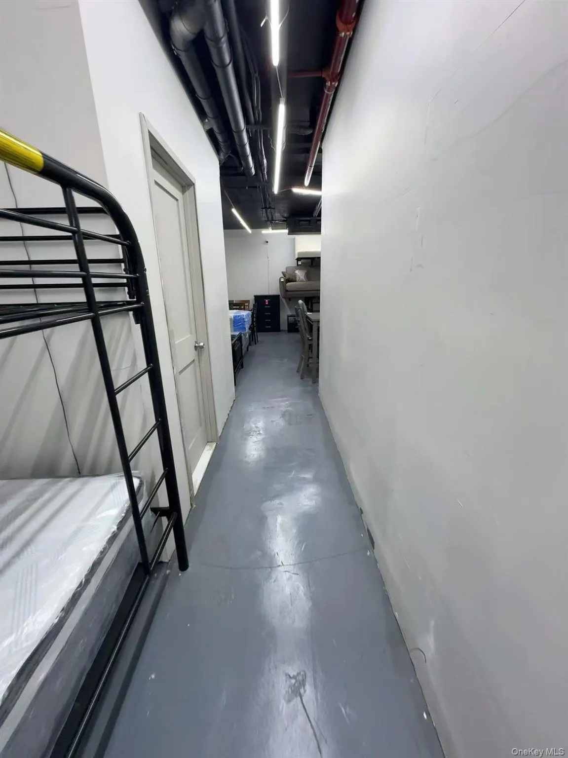 Corridor featuring concrete flooring Corridor featuring concrete flooring