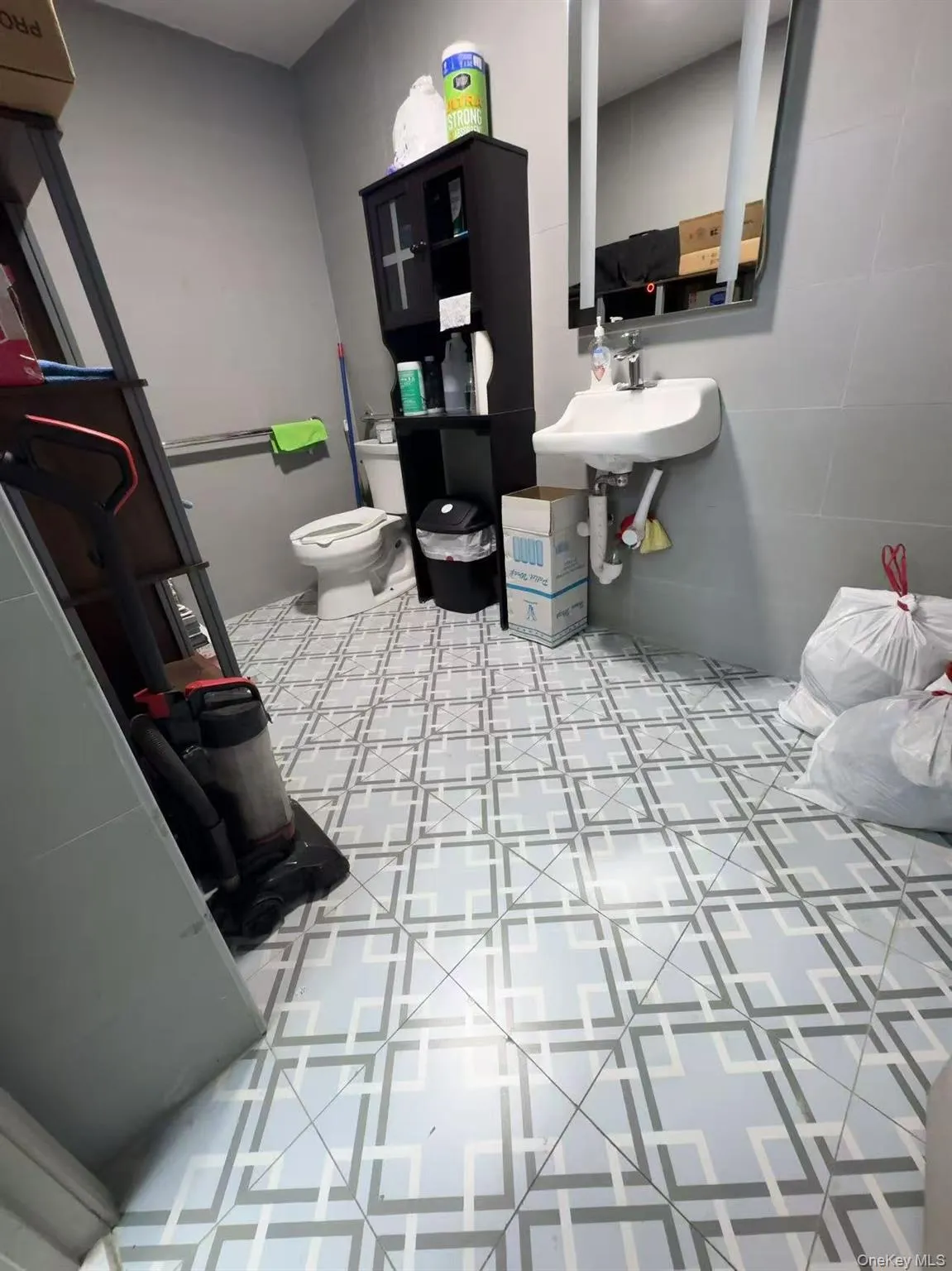 Bathroom featuring toilet and a sink Bathroom featuring toilet and a sink