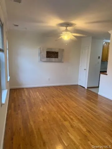 Unfurnished living room featuring light wood-style floors and ceiling fan Unfurnished living room featuring light wood-style floors and ceiling fan