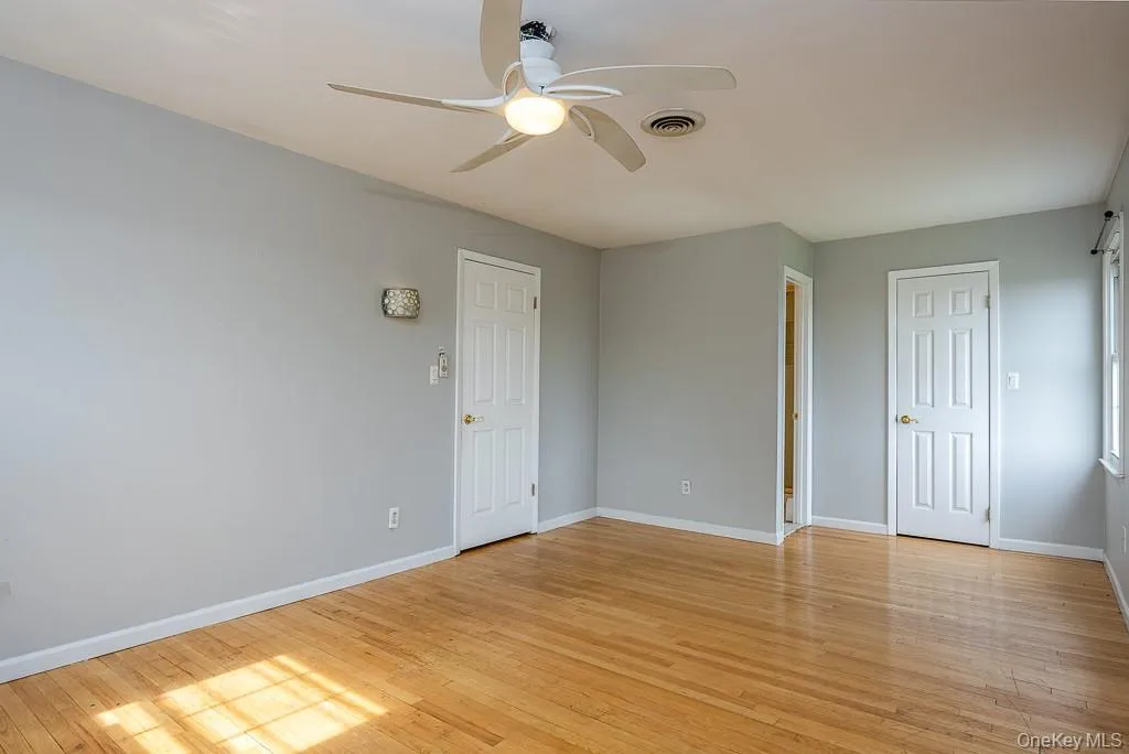 Spare room featuring light wood-style floors and ceiling fan Spare room featuring light wood-style floors and ceiling fan
