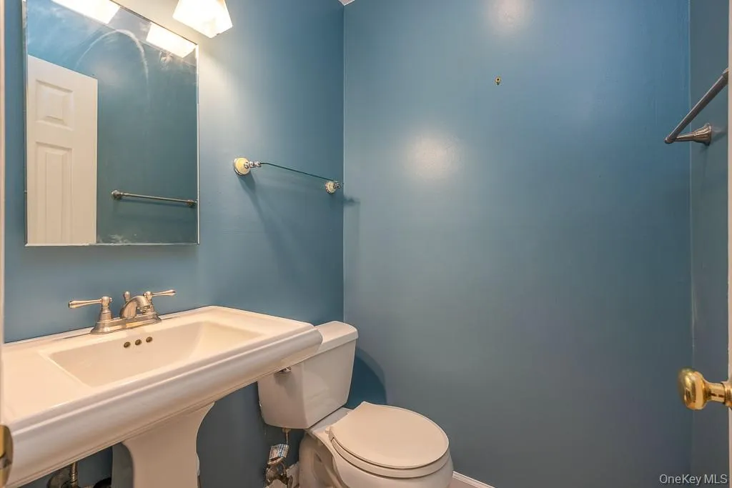 Bathroom featuring toilet and a sink Bathroom featuring toilet and a sink