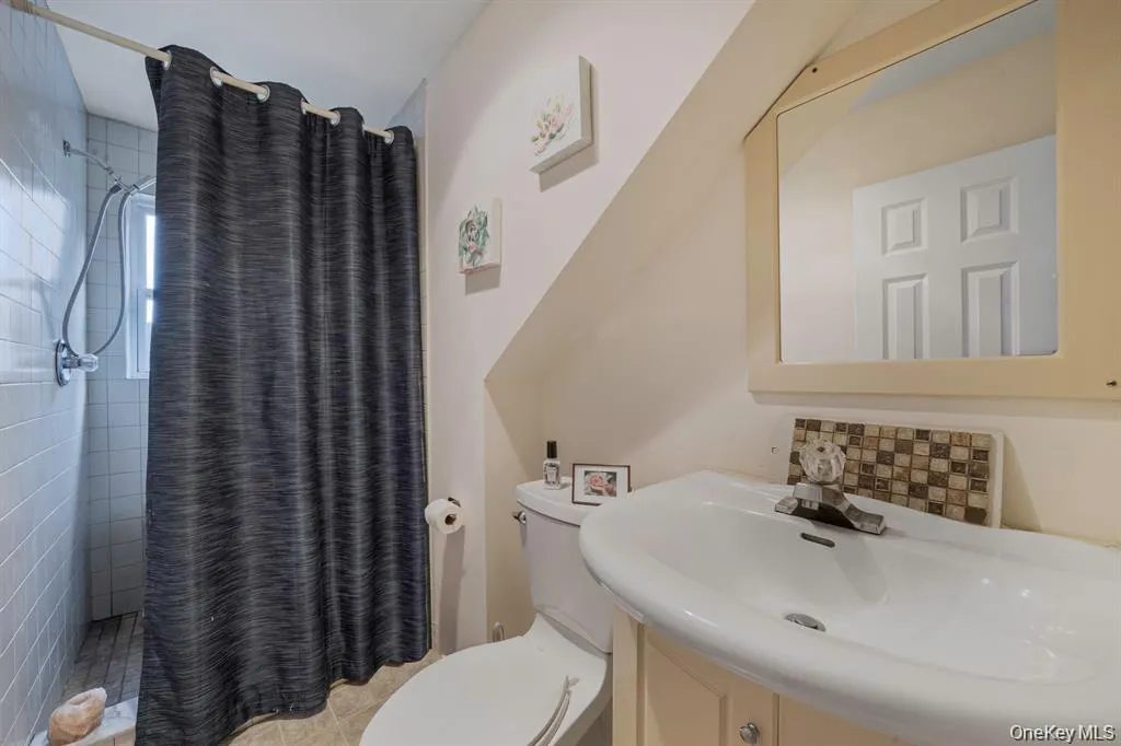 Full bathroom featuring a shower stall and vanity Full bathroom featuring a shower stall and vanity